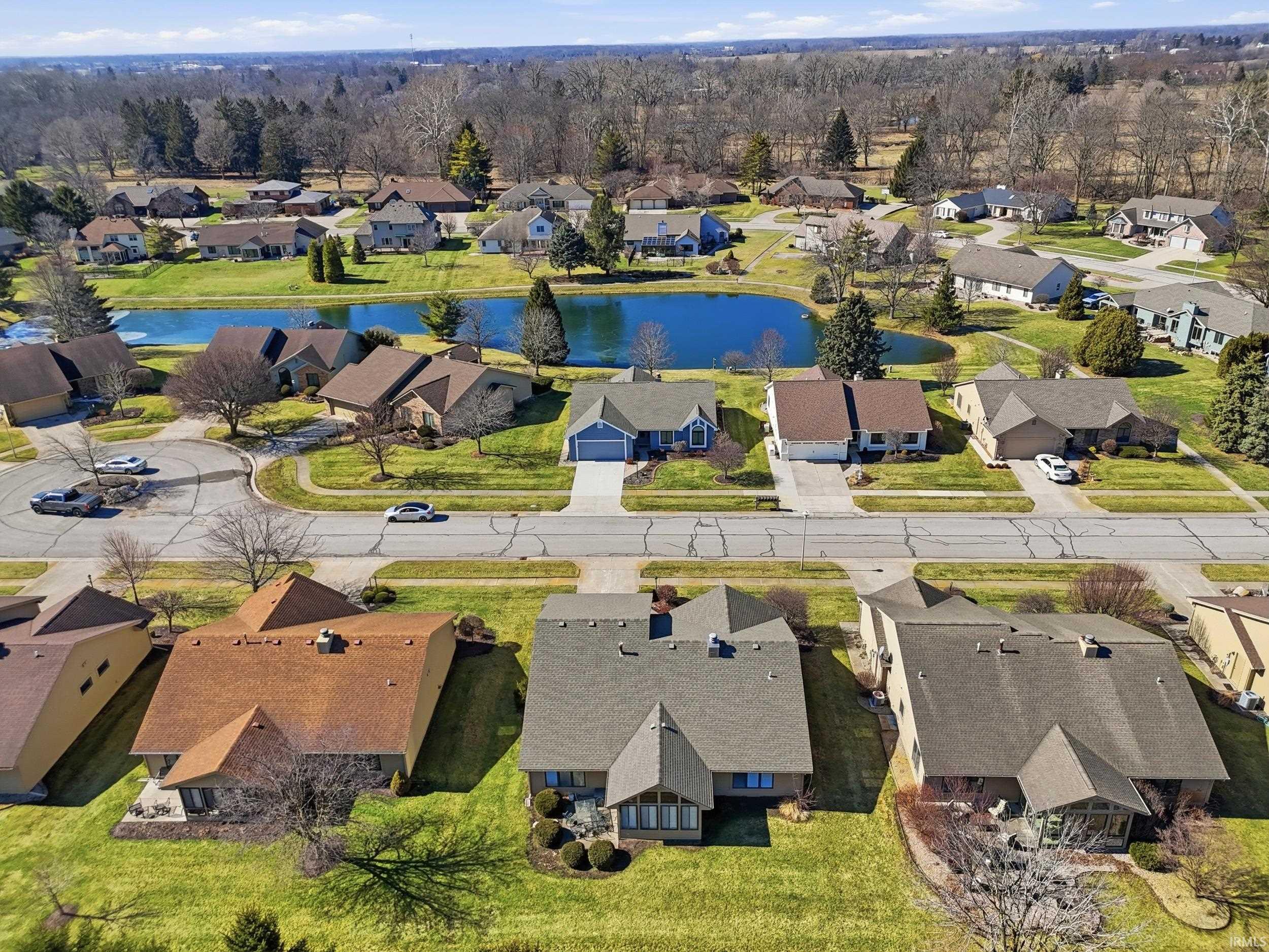 Aerial perspective of suburban area featuring a large body of water
