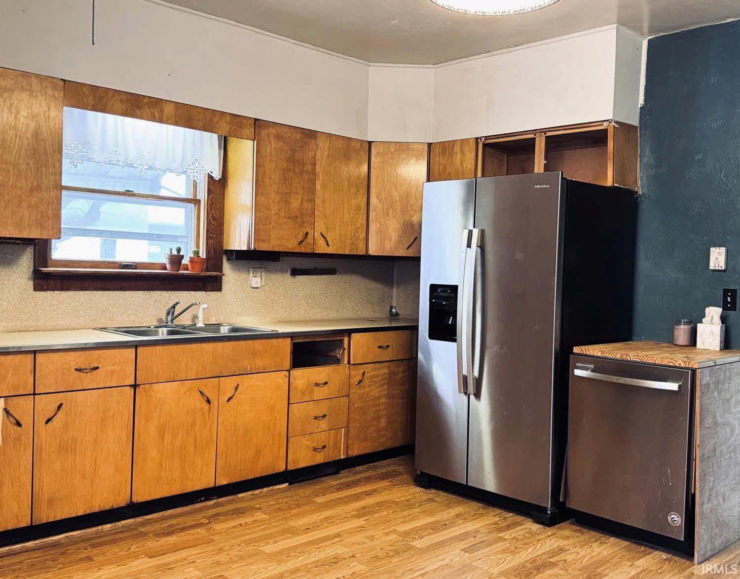 Kitchen featuring stainless steel appliances, light wood-type flooring, wood finish cabinetry, and open shelves