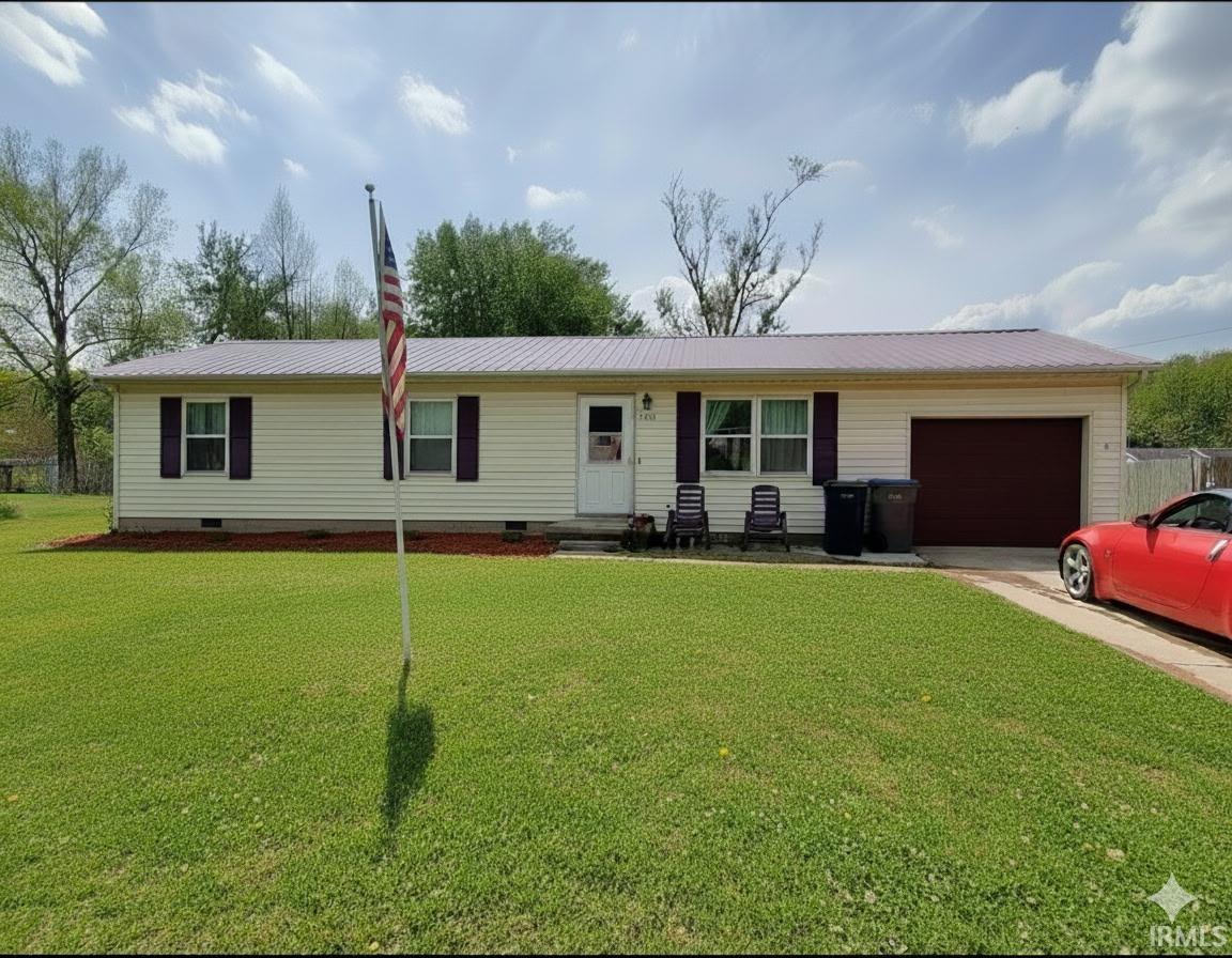 Ranch-style house with crawl space, a metal roof, an attached garage, driveway, and a front lawn