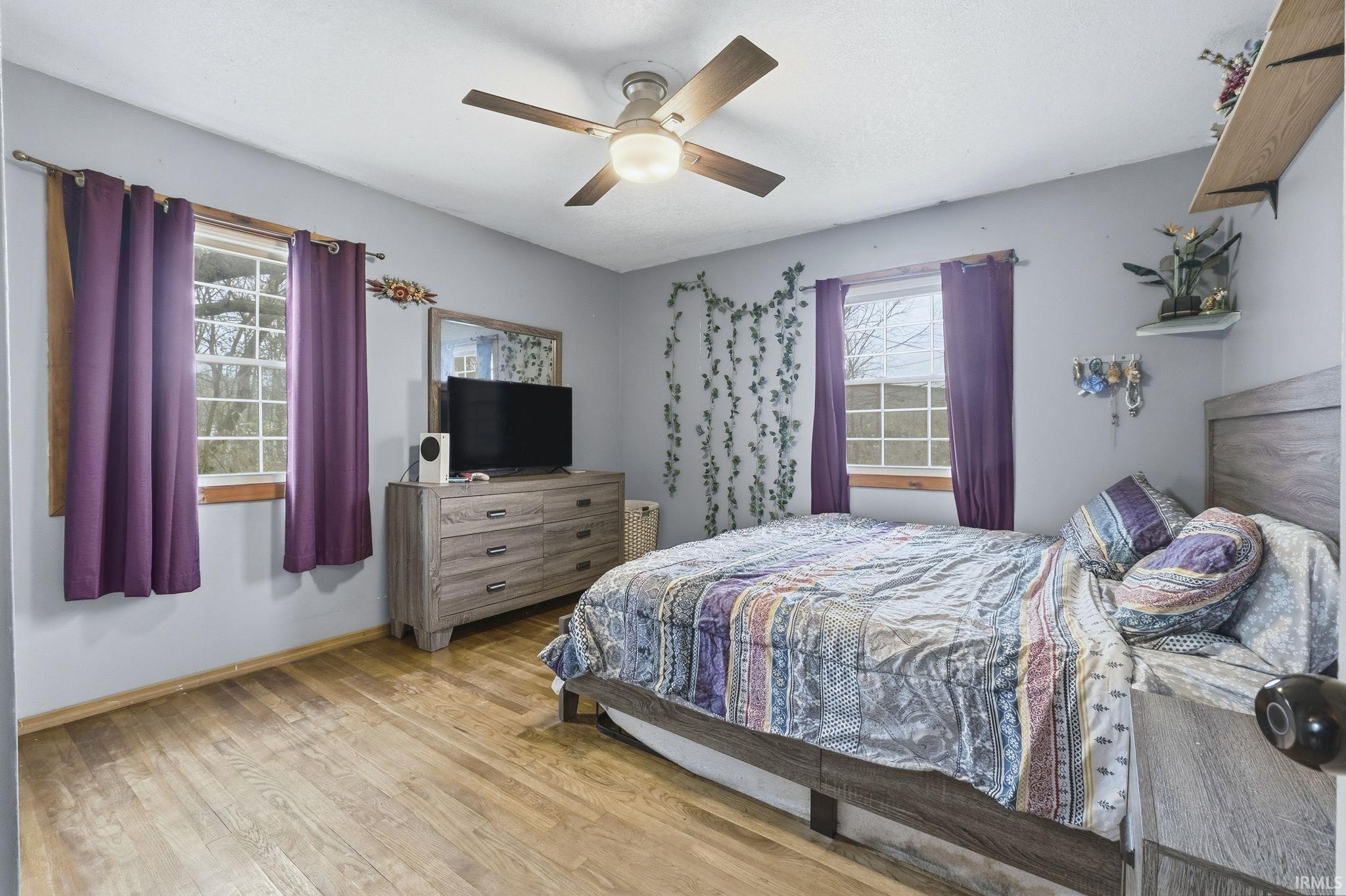 Bedroom featuring wood finished floors and ceiling fan