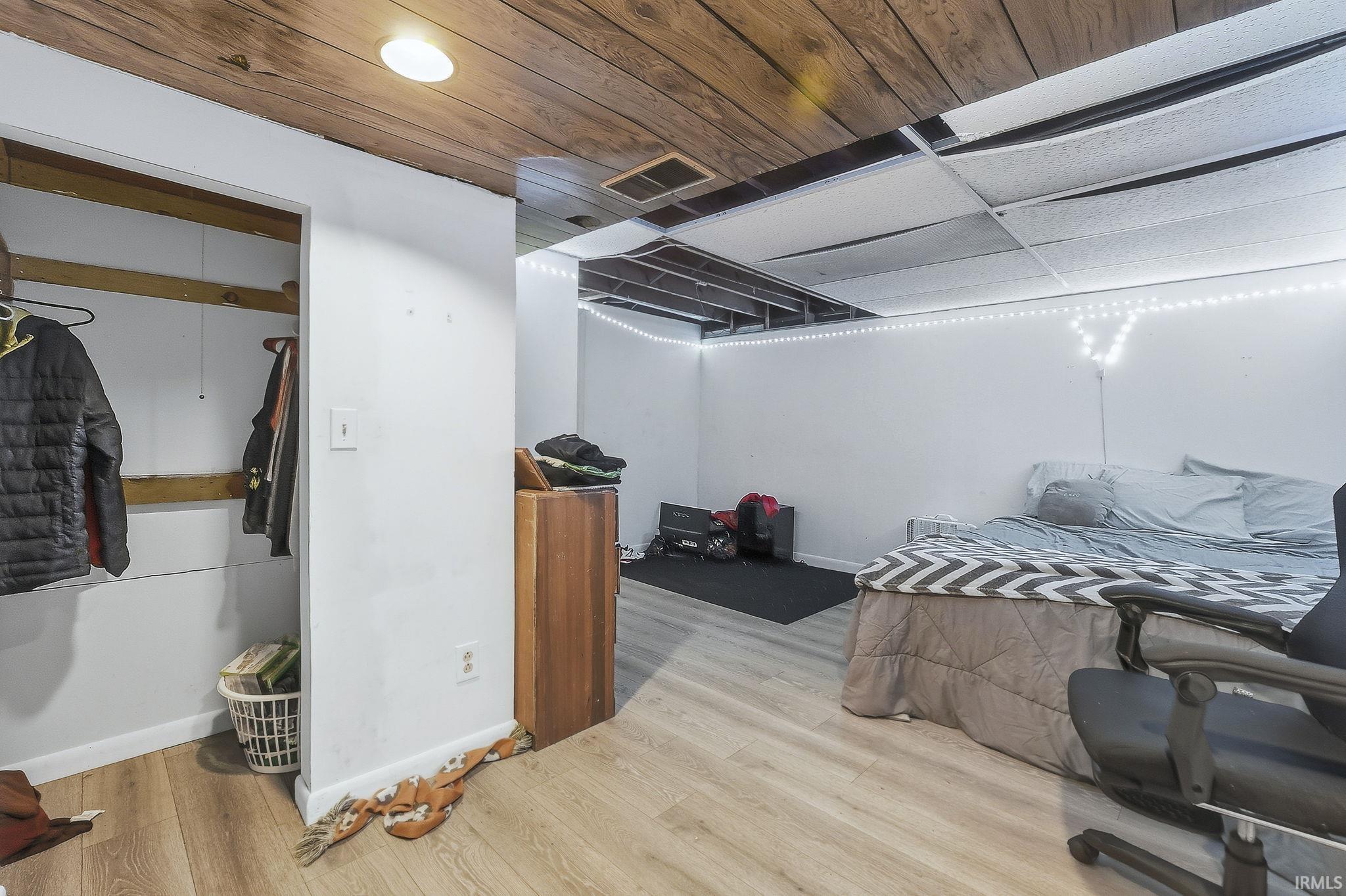 Bedroom with wood finished floors and wood ceiling