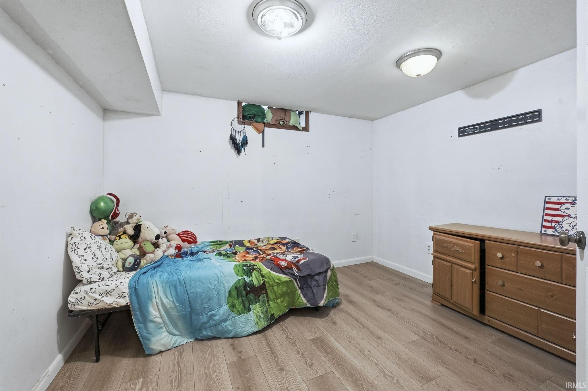Bedroom with baseboards and light wood-style floors