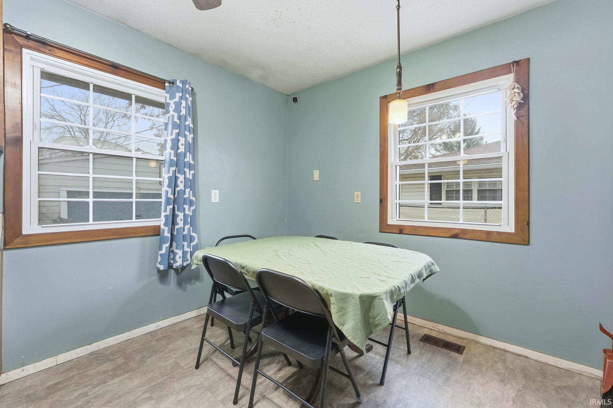 Dining space featuring baseboards and tile patterned floors