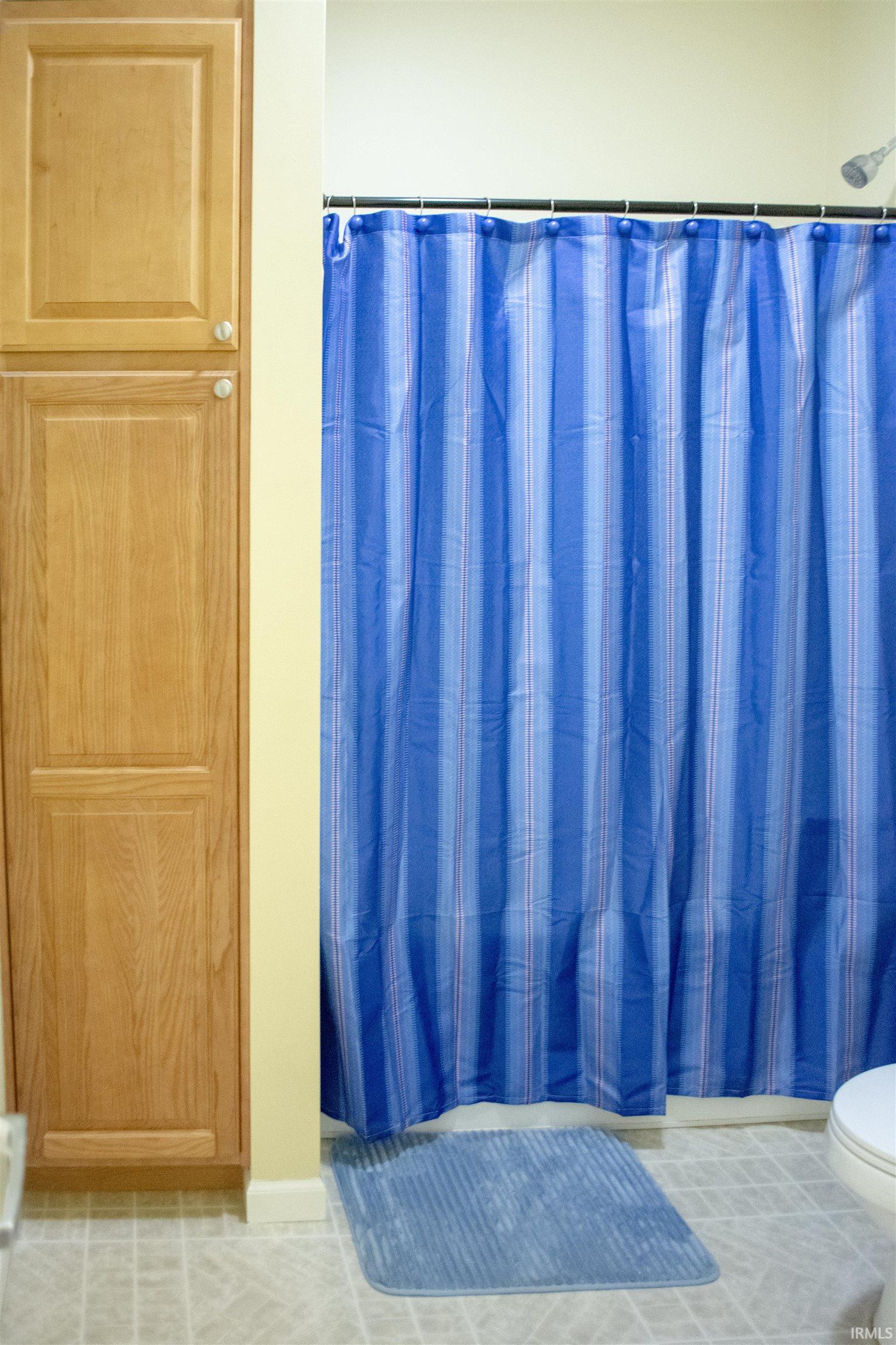 Full bath featuring toilet and shower / tub combo