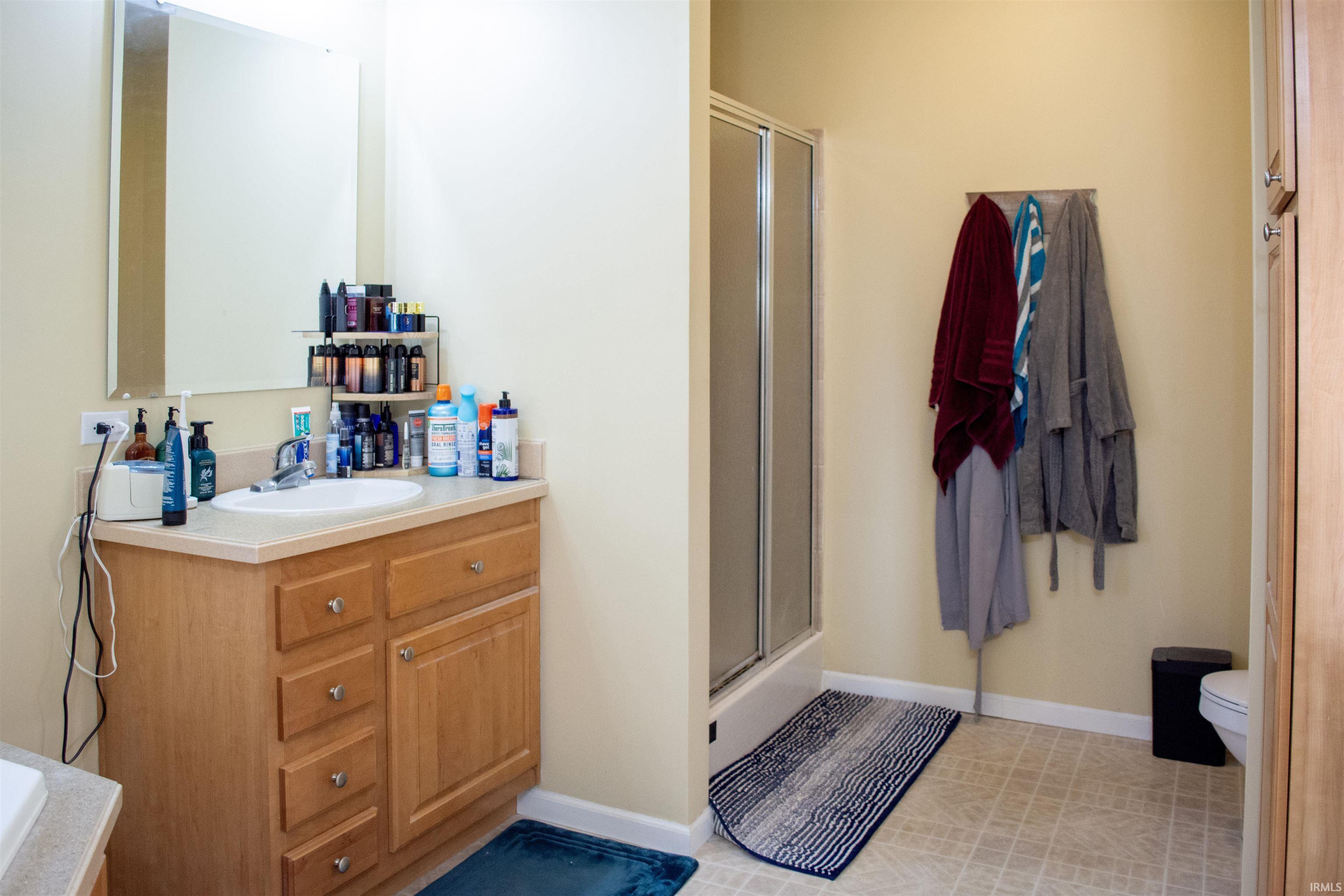 Bathroom with vanity and a shower stall