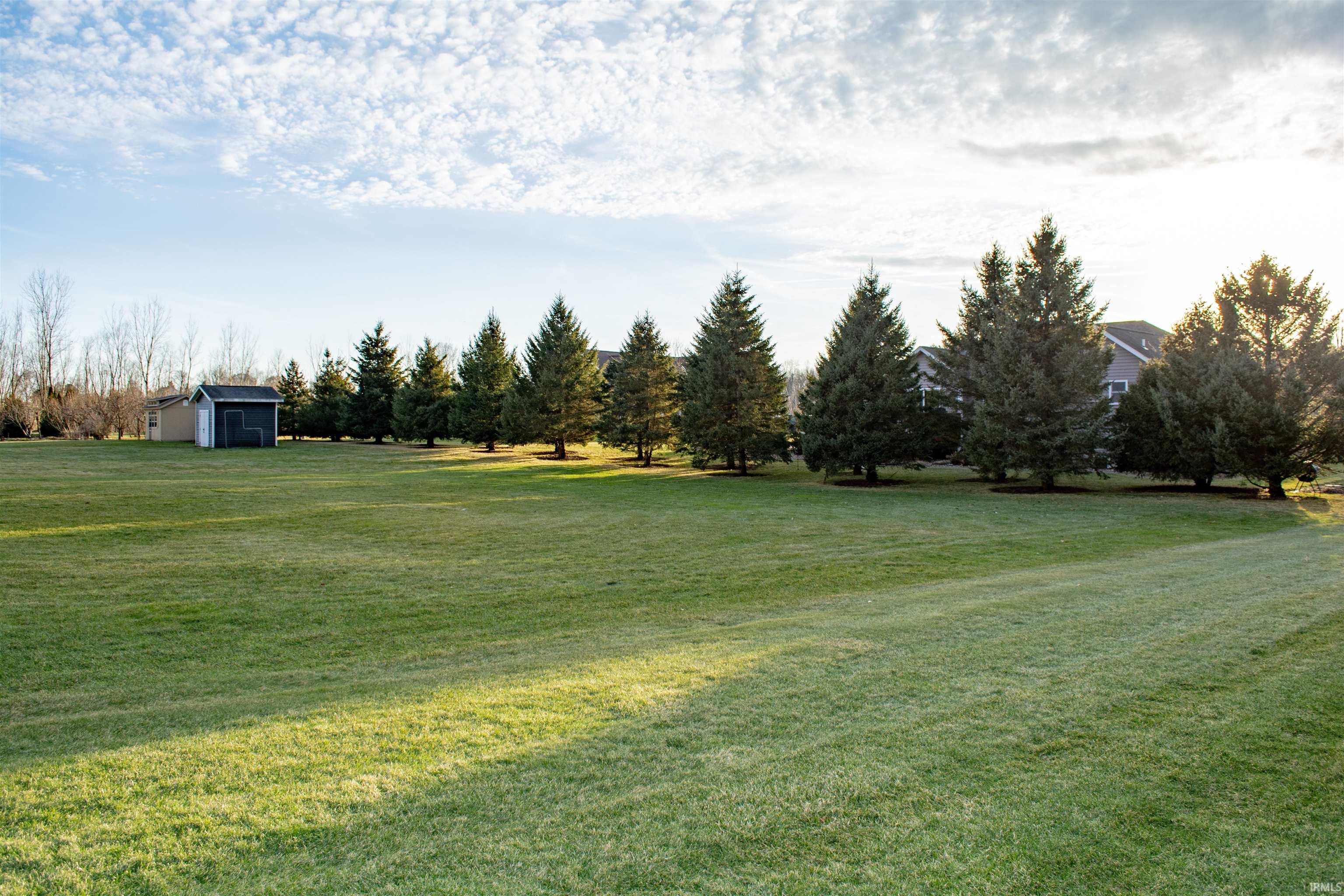 View of grassy yard with an outdoor structure