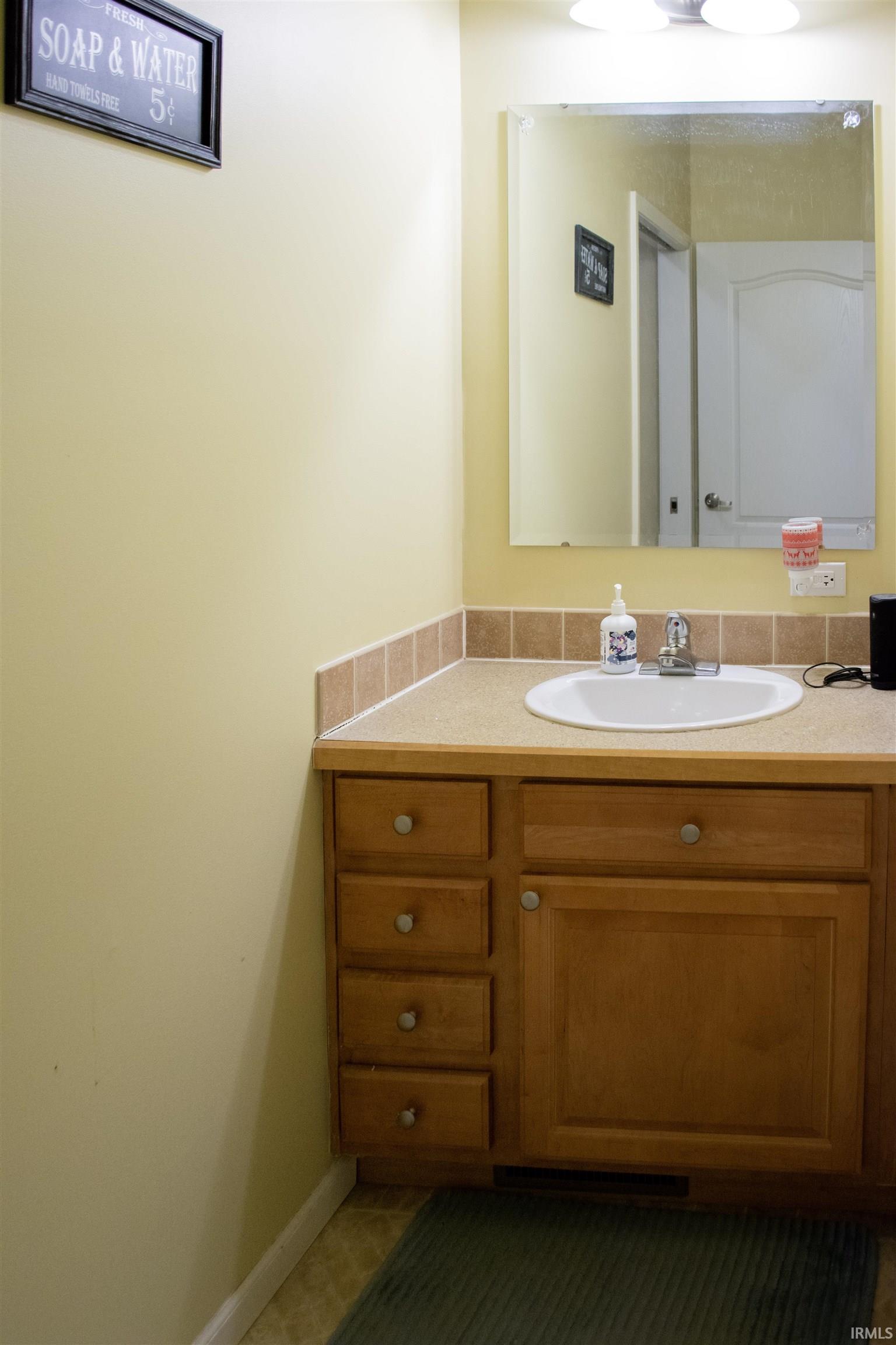 Bathroom featuring vanity and baseboards