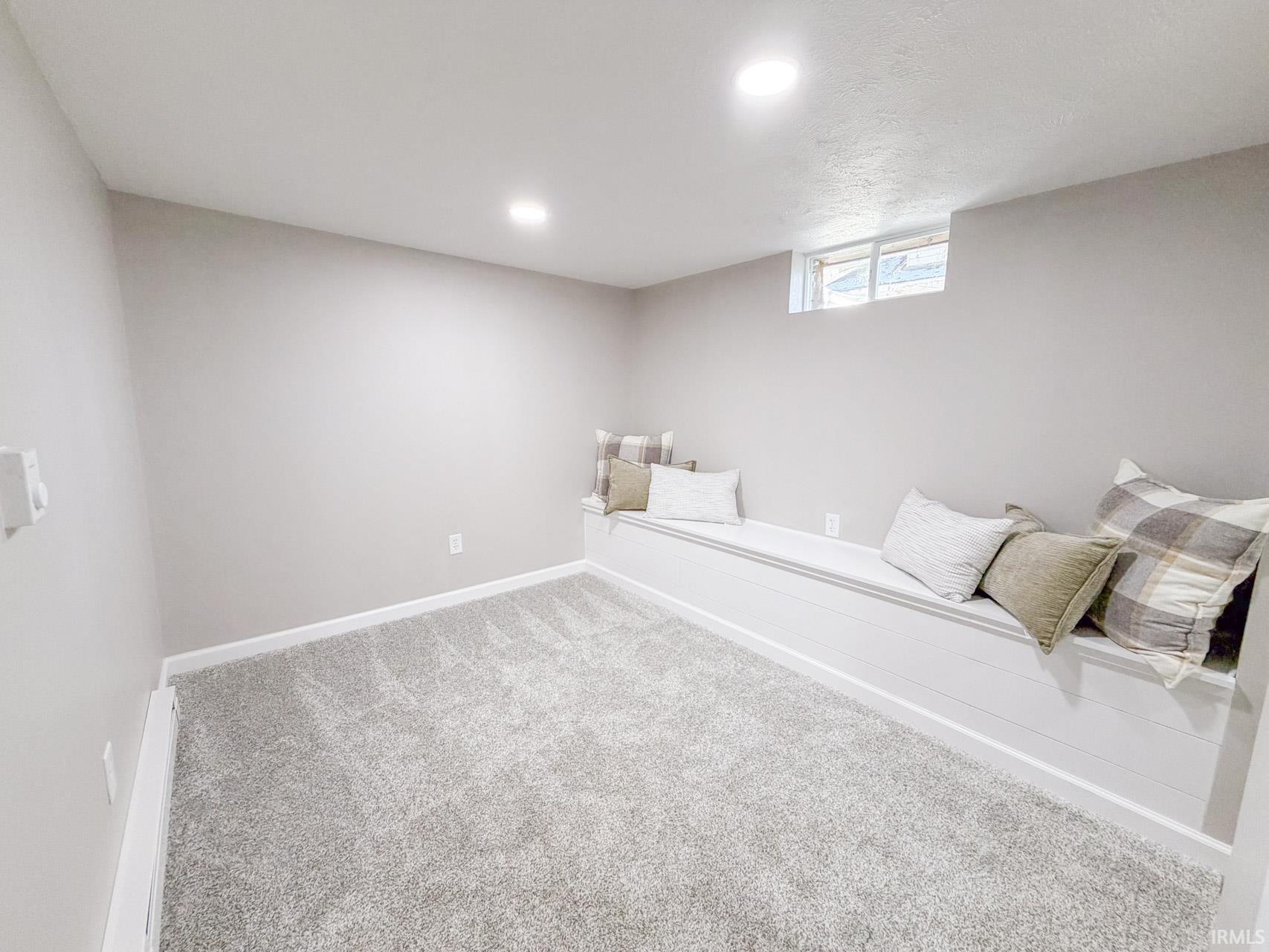 Bedroom with light carpet and recessed lighting