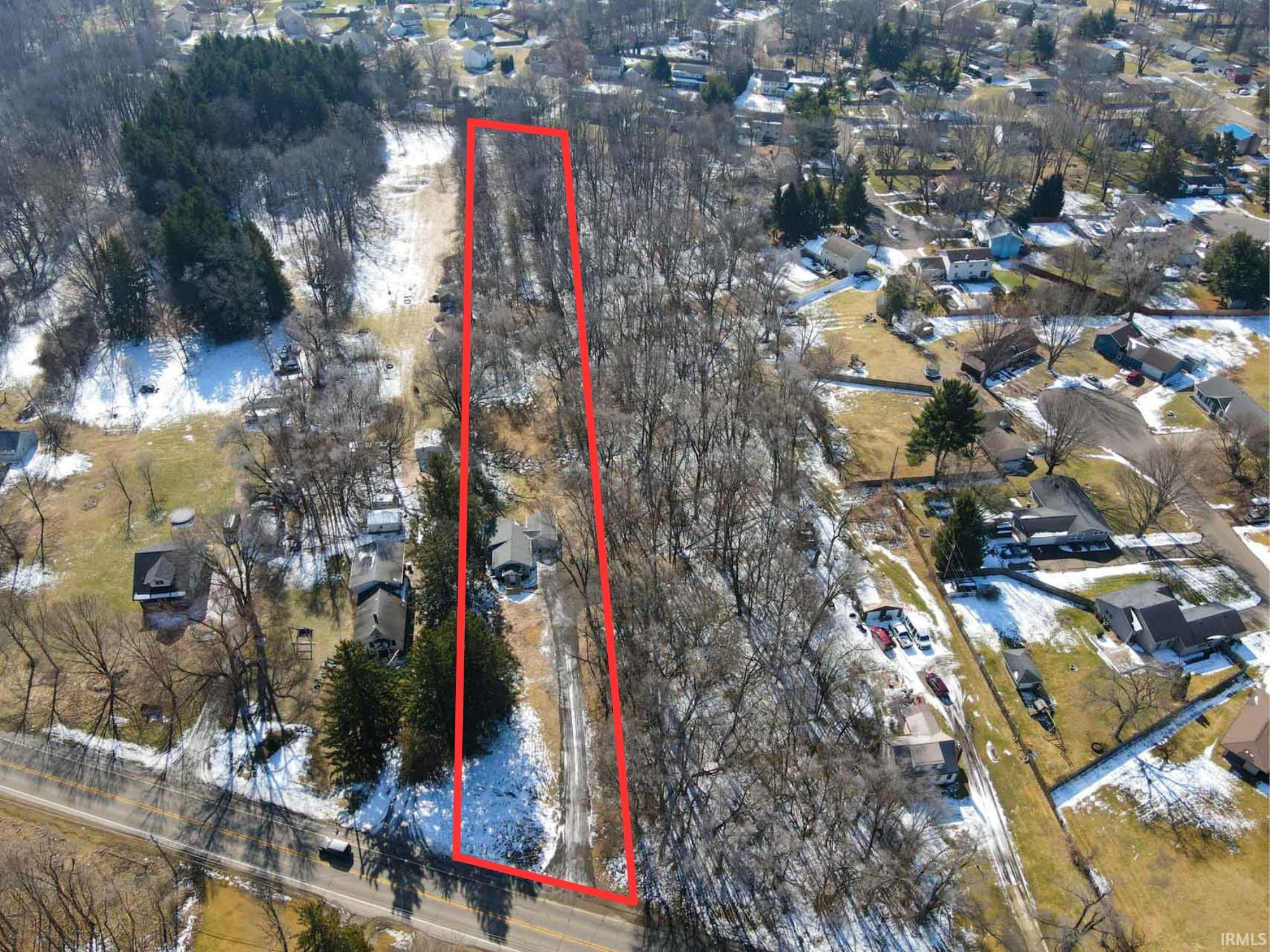 Aerial view of residential area with property parcel outlined