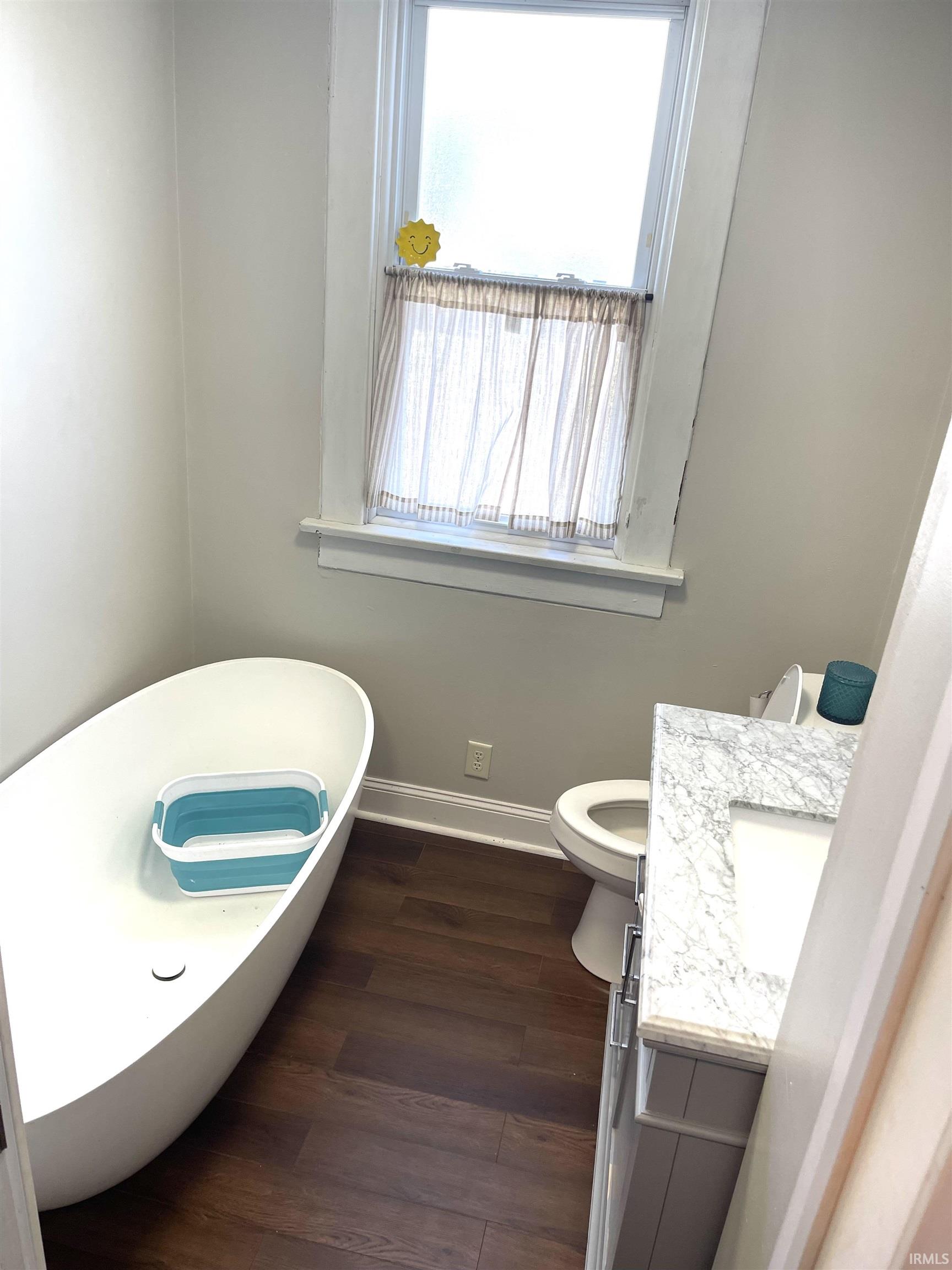 Downstairs bathroom with new flooring, and a freestanding bath