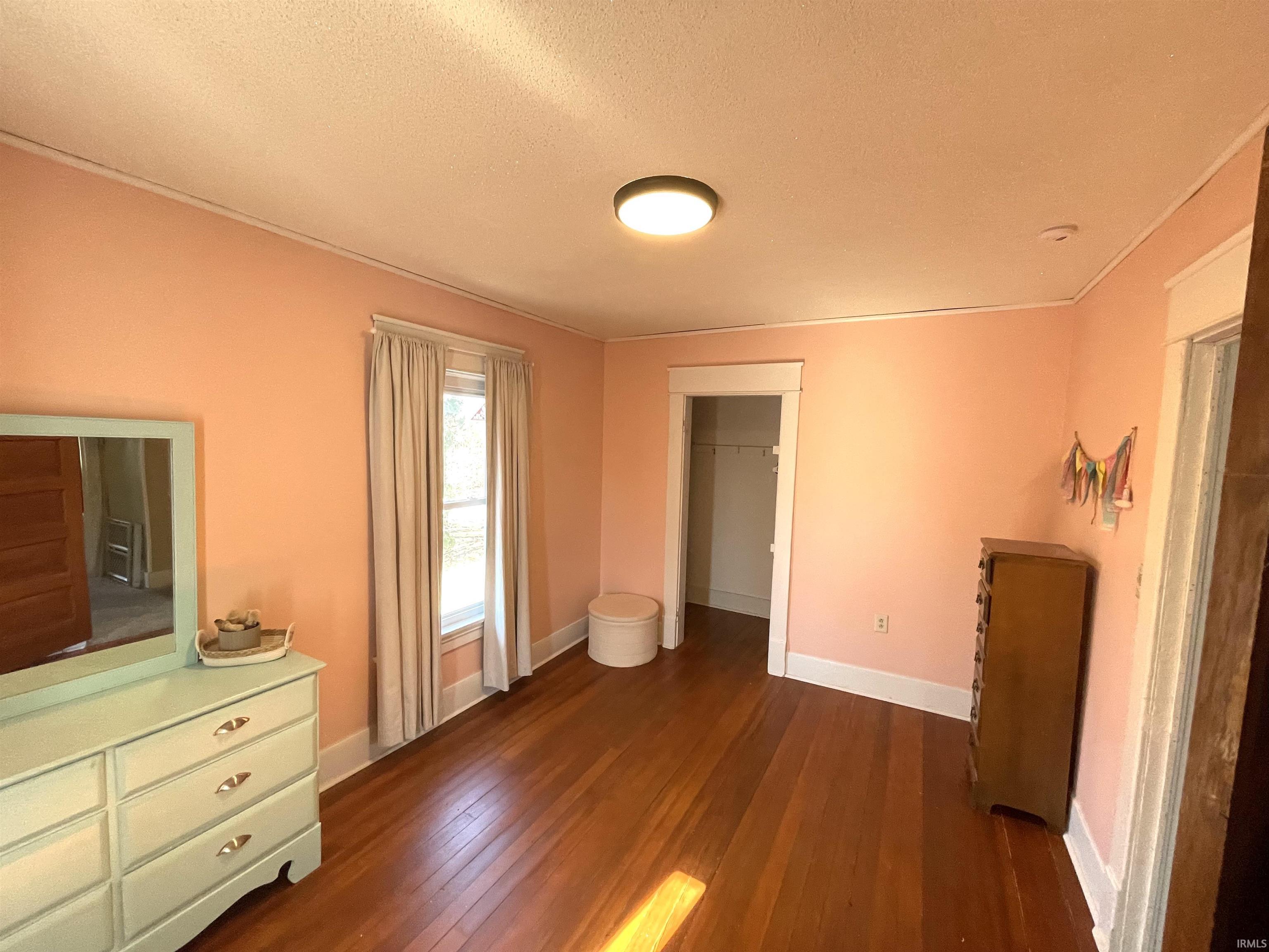 3rd bedroom with original wood flooring