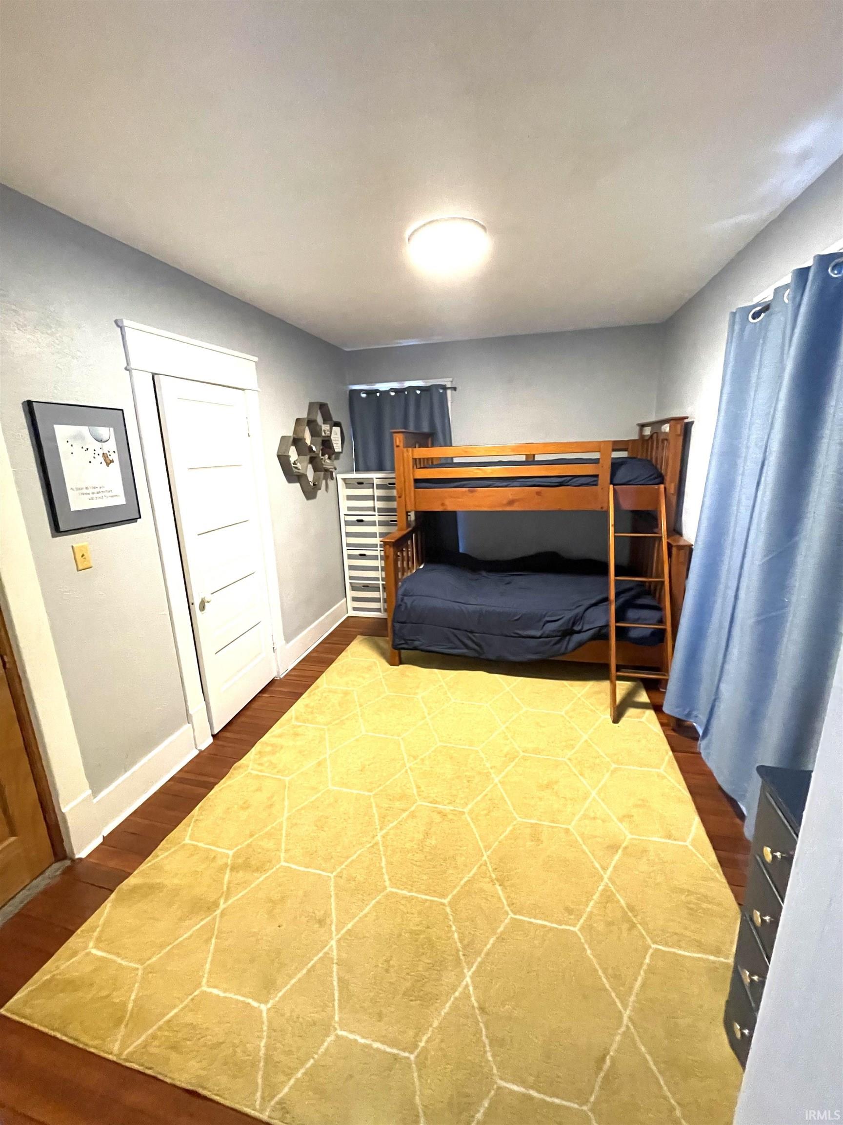 4th bedroom with original wood flooring