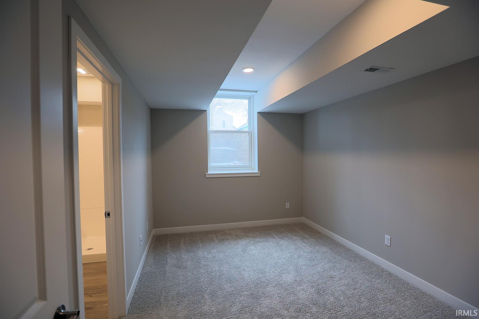 Additional living space featuring carpet flooring and recessed lighting