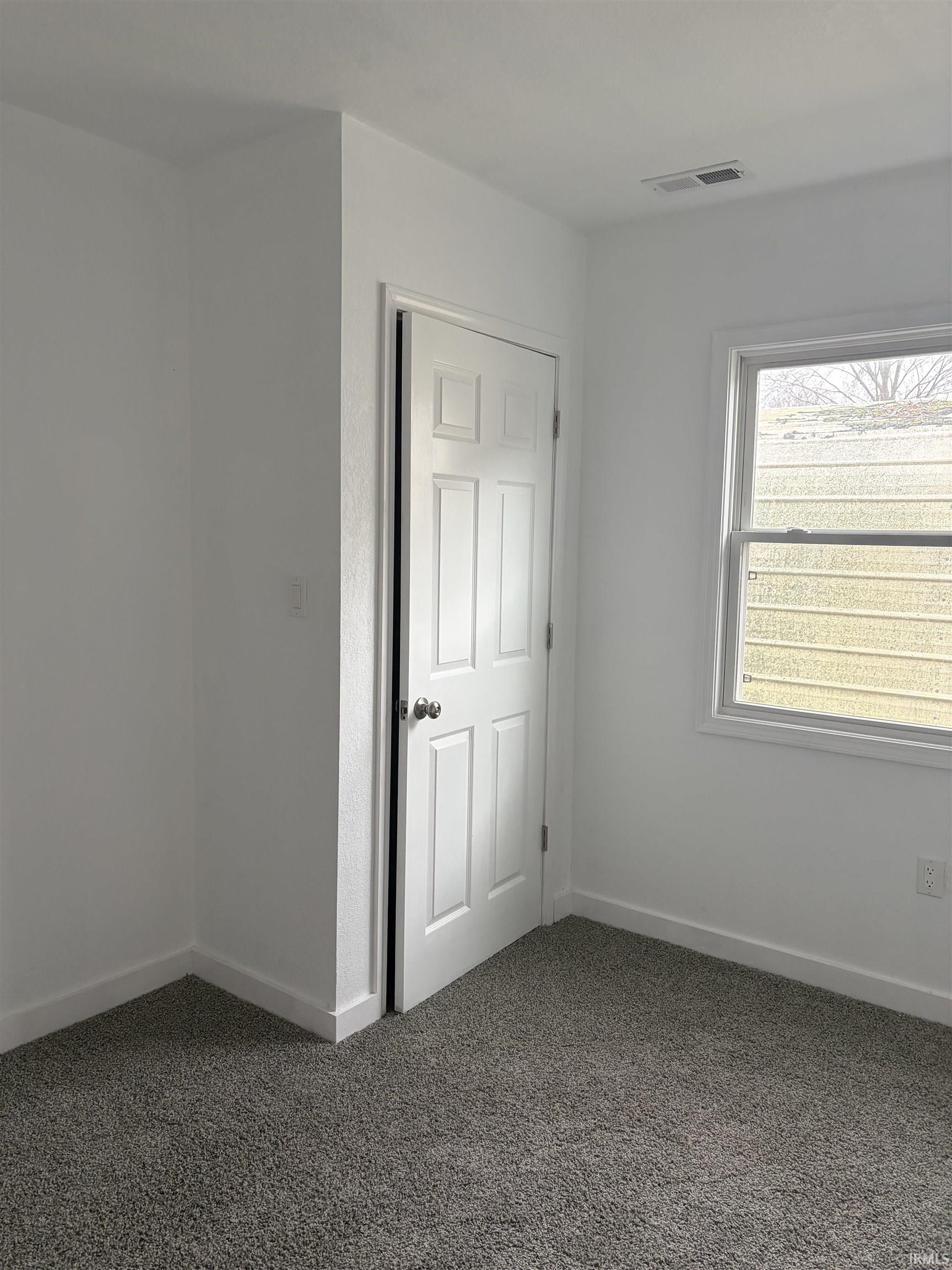 Unfurnished room featuring carpet flooring and baseboards