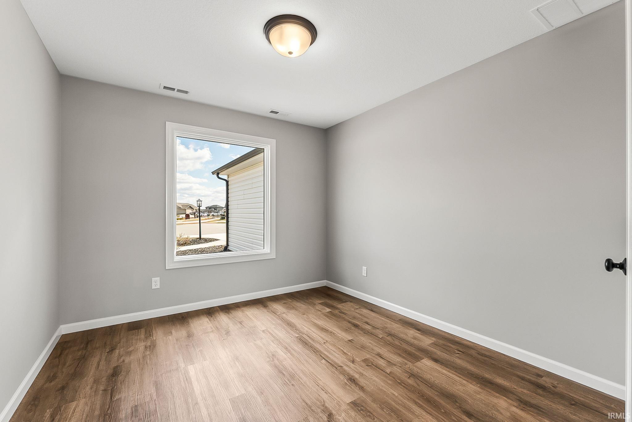 Unfurnished room featuring light wood-style flooring and baseboards