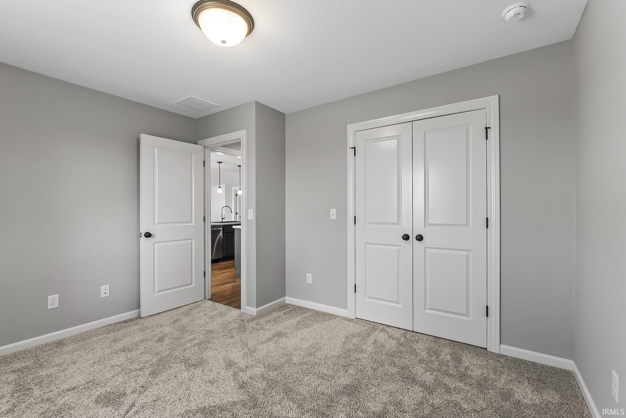 Unfurnished bedroom featuring carpet floors and a closet