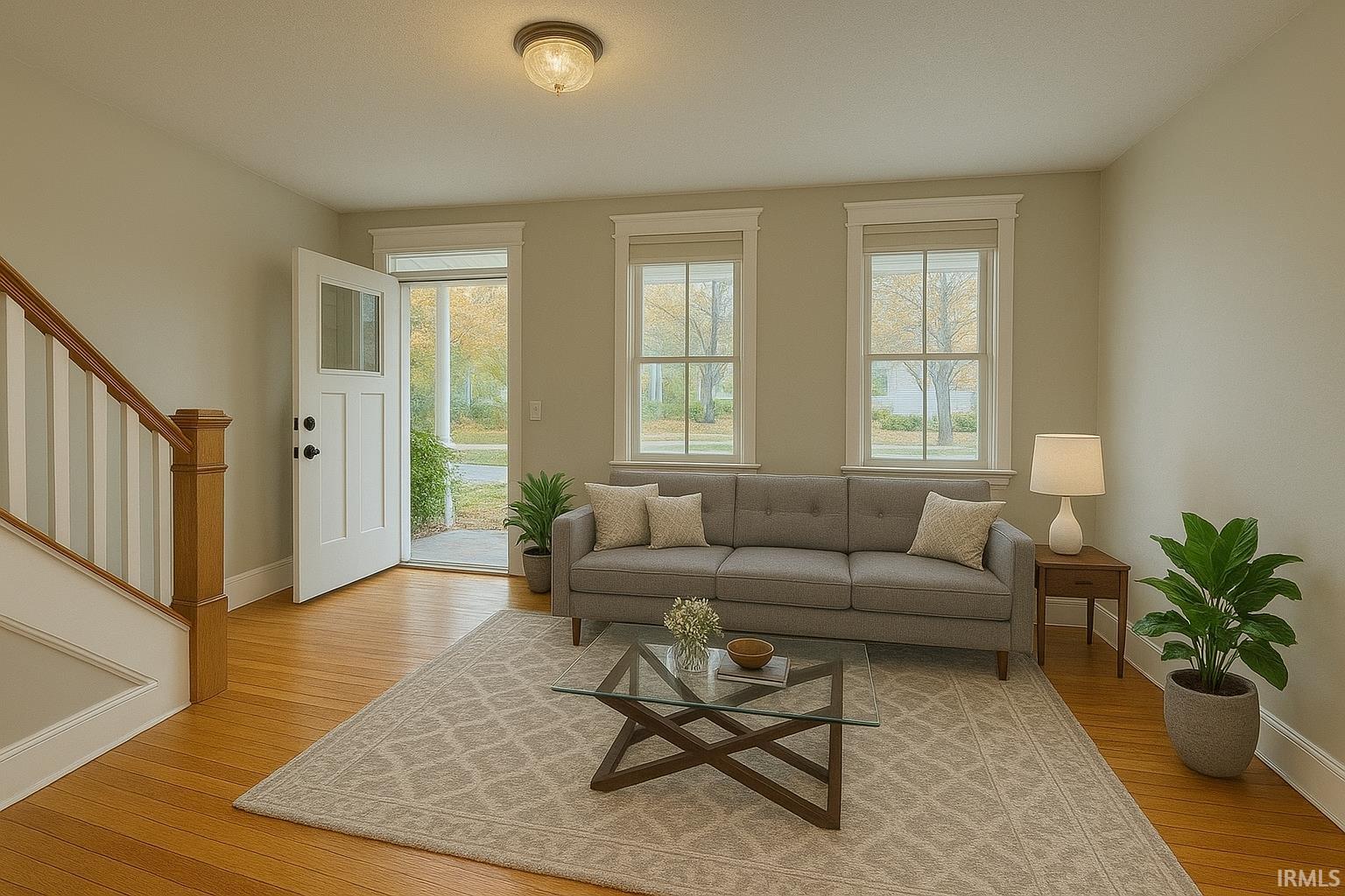 Living room featuring stairs and light wood finished floors