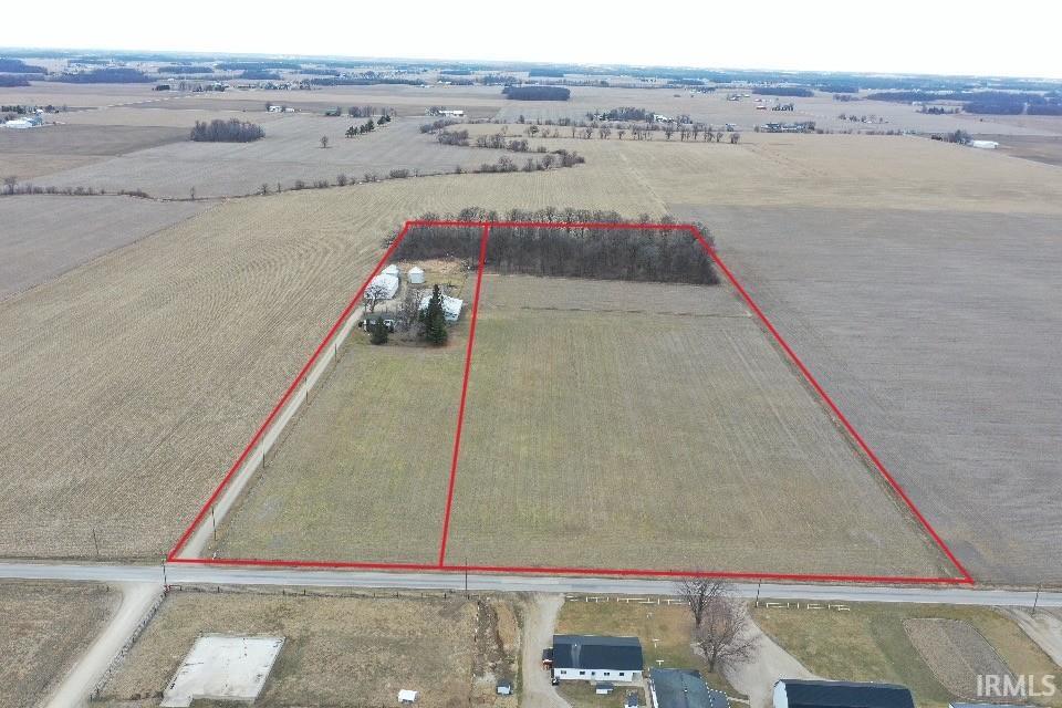 Aerial view of sparsely populated area featuring property boundaries highlighted