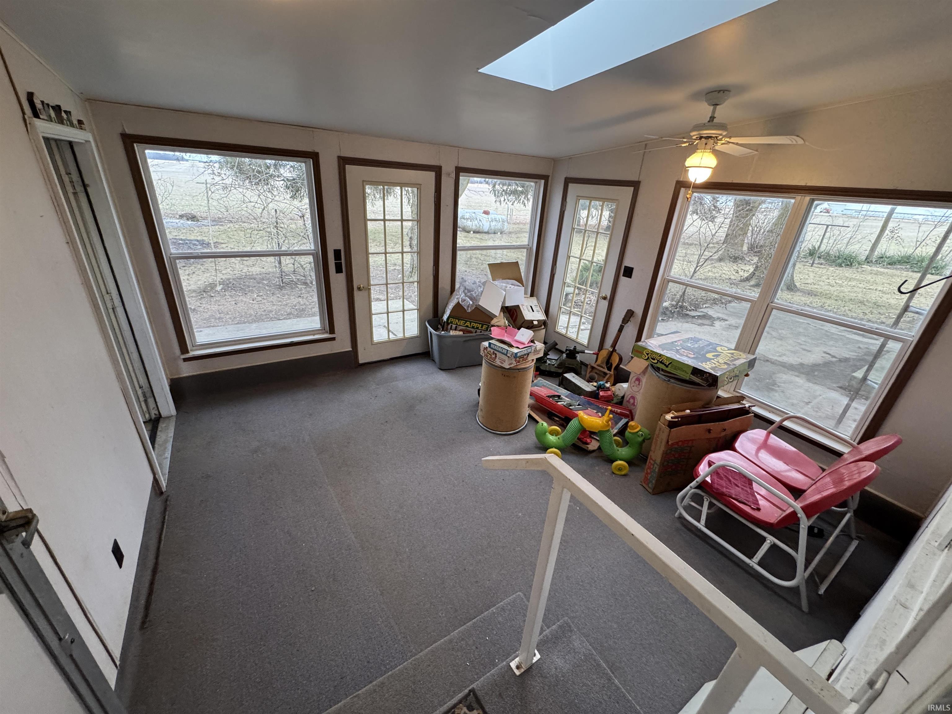 Sunroom featuring a skylight and lofted ceiling