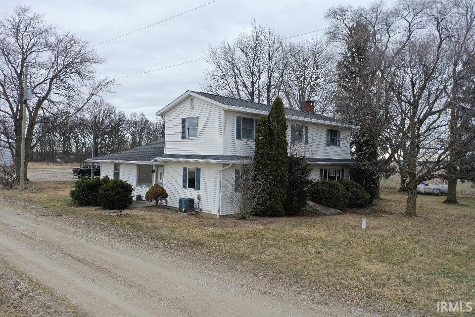 Traditional home with a chimney and a front yard
