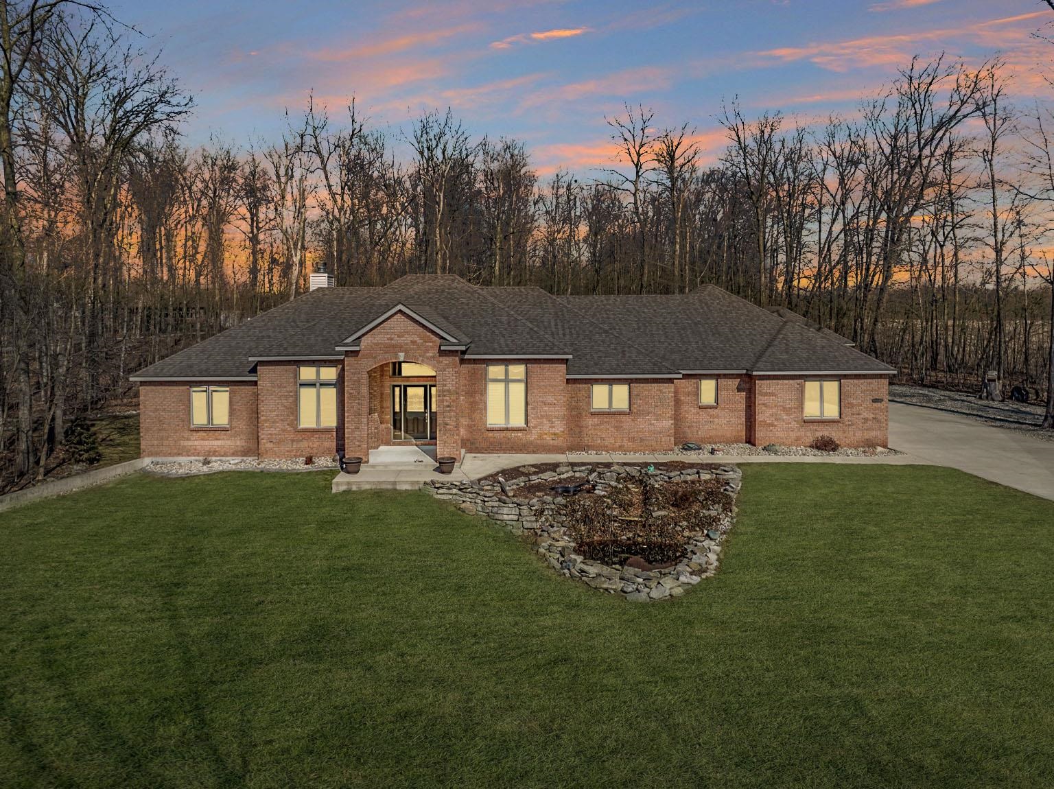 Single story home with brick siding, a lawn, a chimney, and a shingled roof