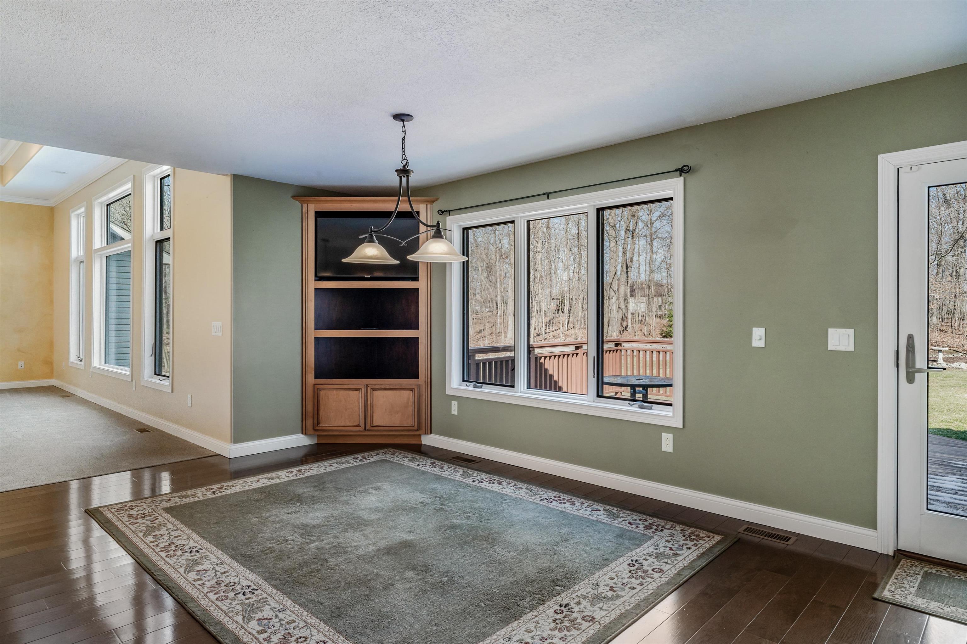 Unfurnished dining area featuring dark wood finished floors and a textured ceiling