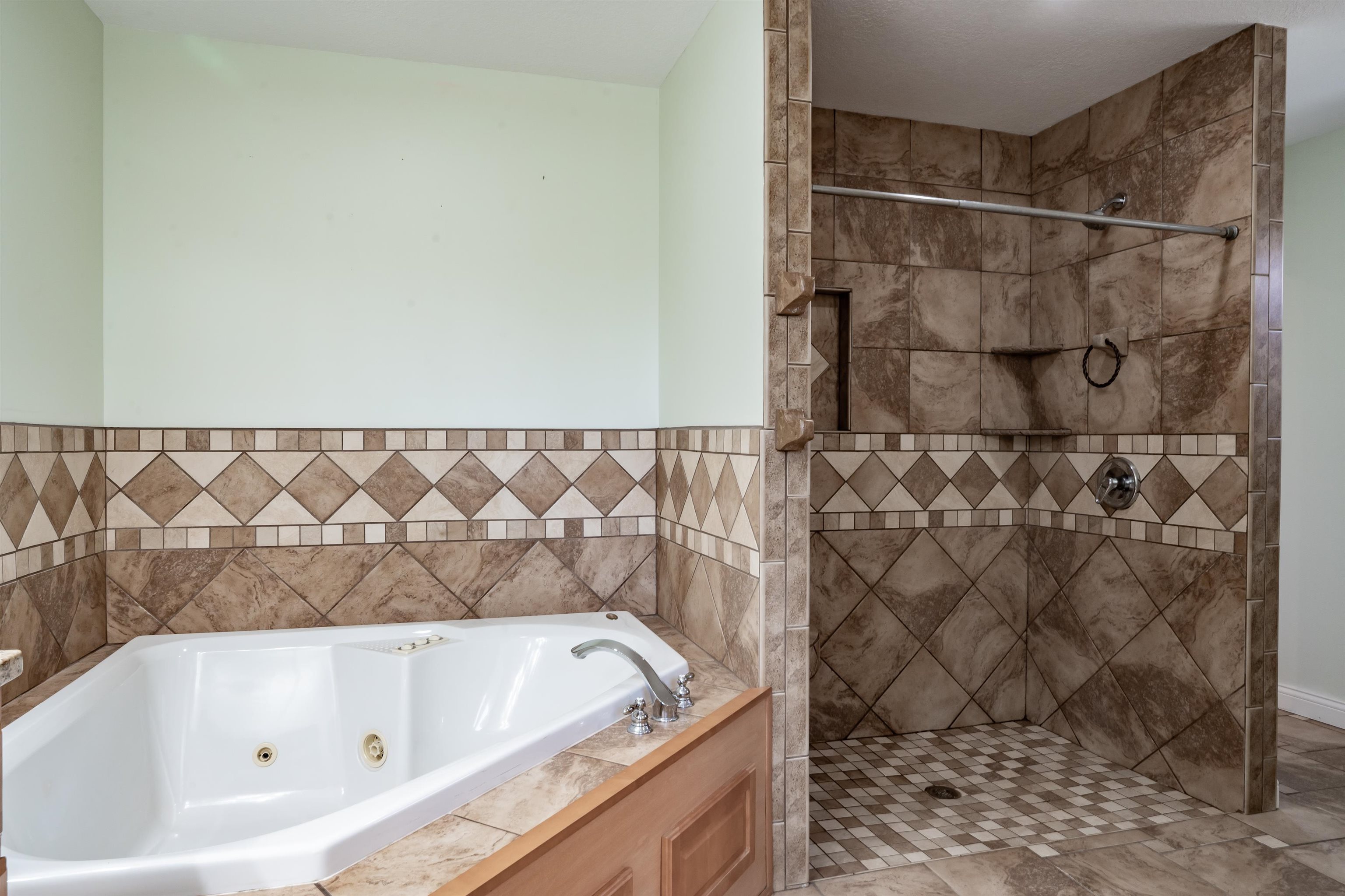 Bathroom with a whirlpool tub and a shower stall