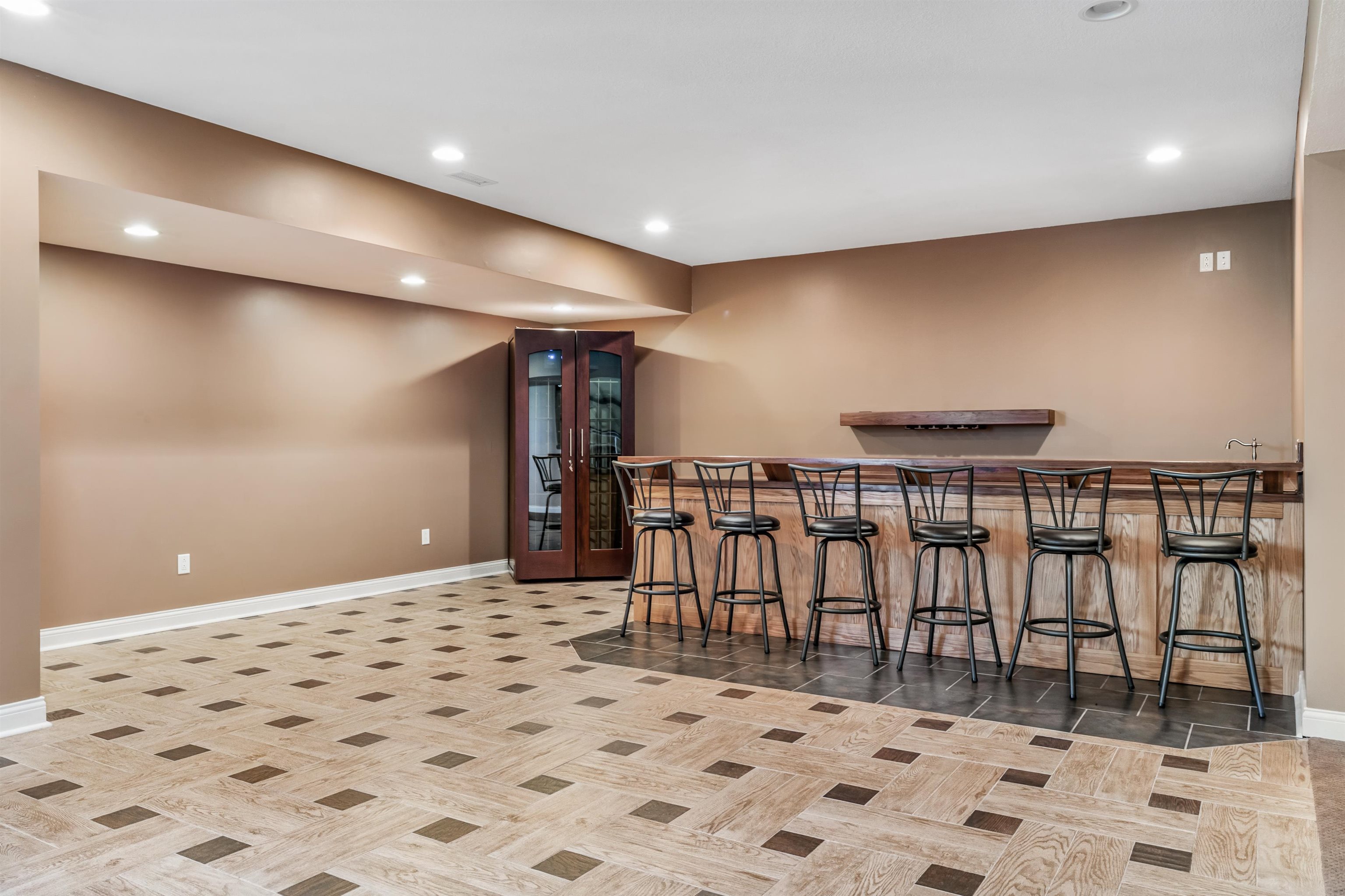 Indoor wet bar featuring recessed lighting and parquet flooring