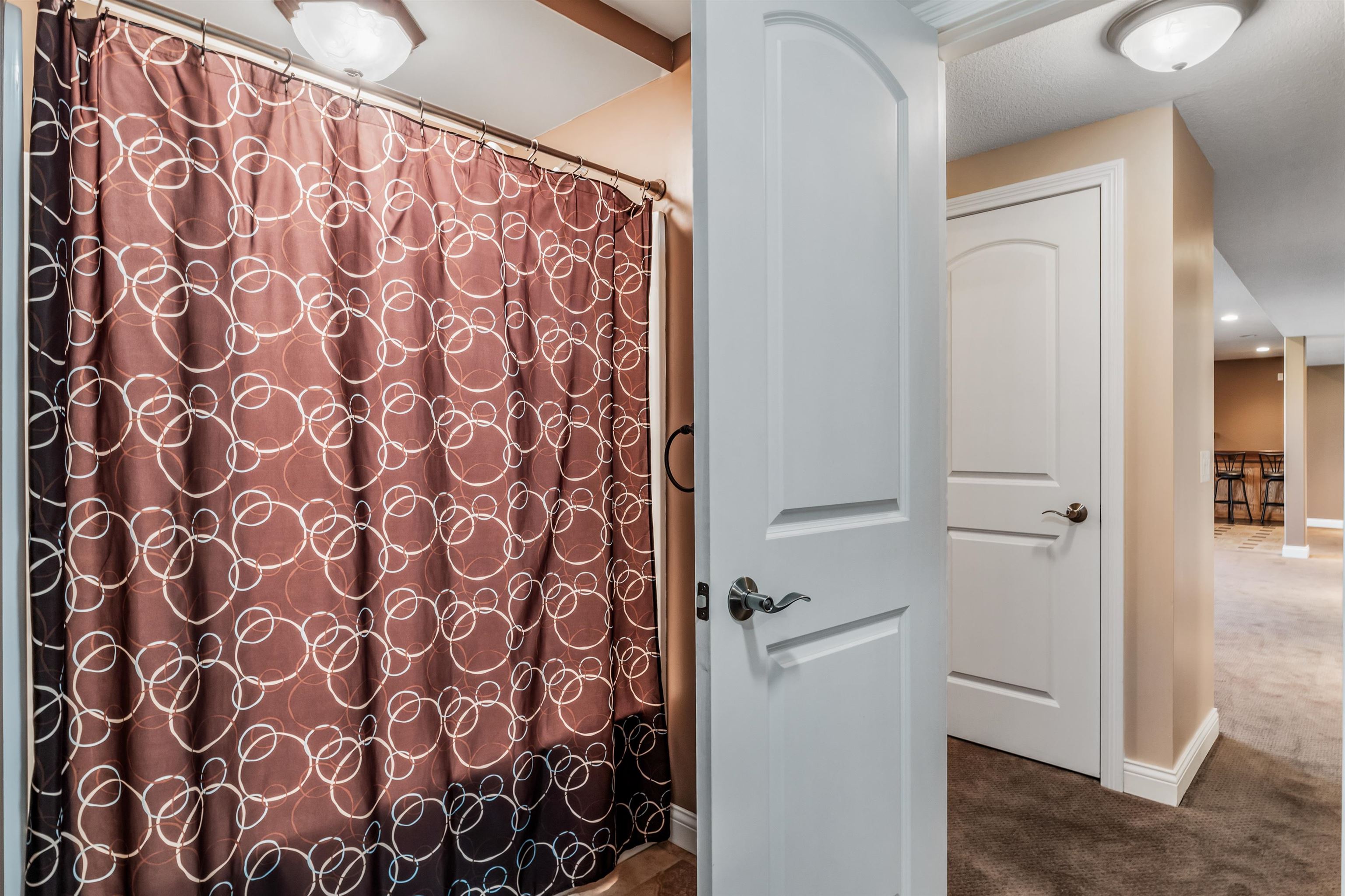 Bathroom featuring dark colored carpet, a shower with curtain, and recessed lighting