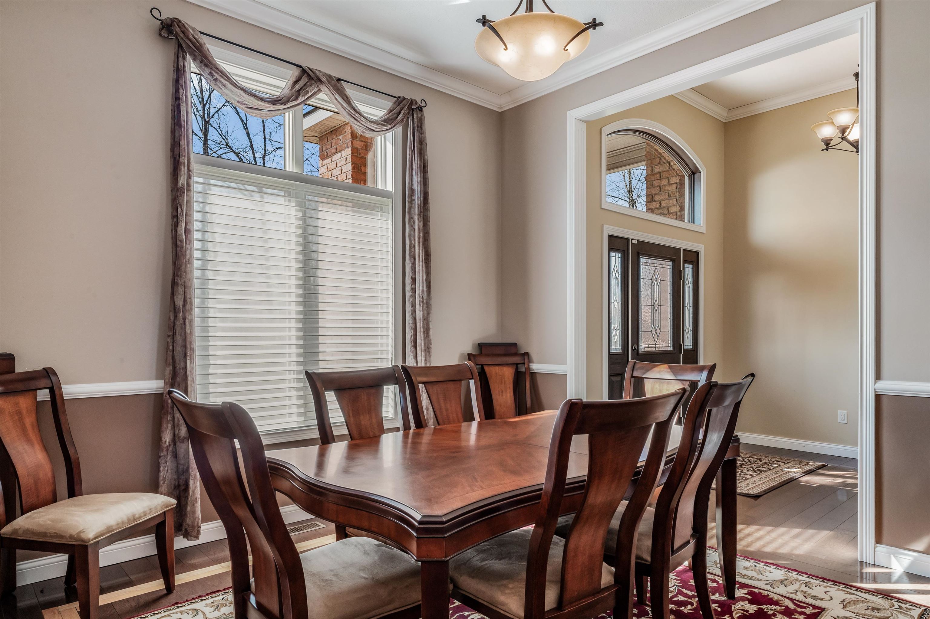 Dining room with wood finished floors and ornamental molding