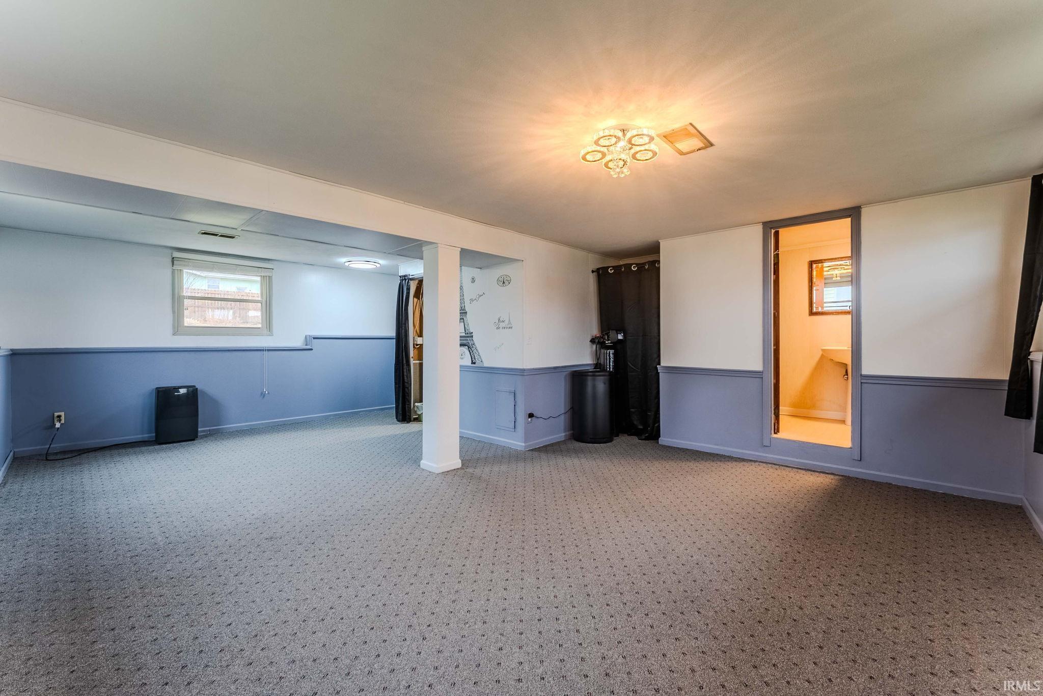 Carpeted empty room with baseboards