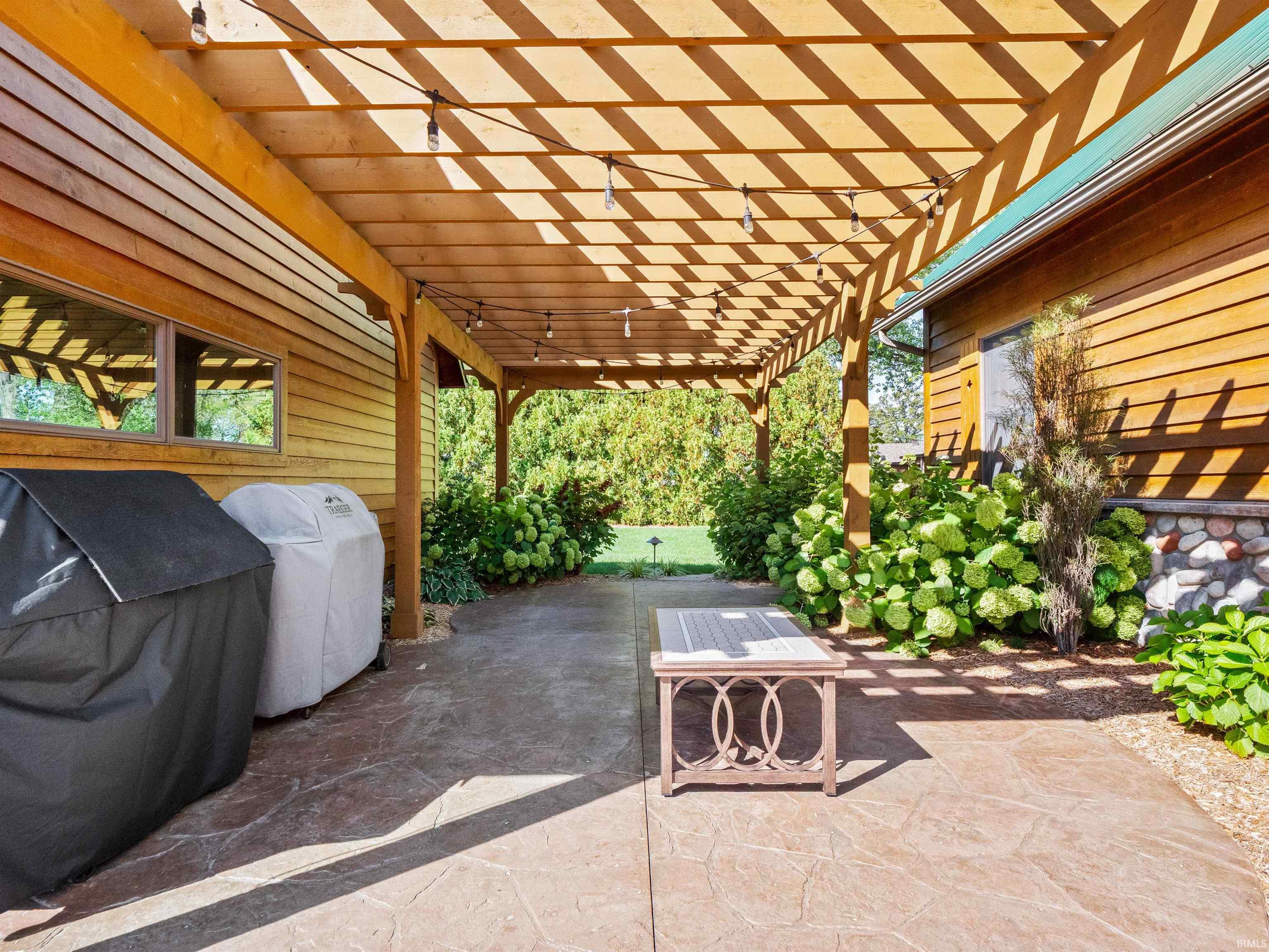 View of patio featuring grilling area and a pergola