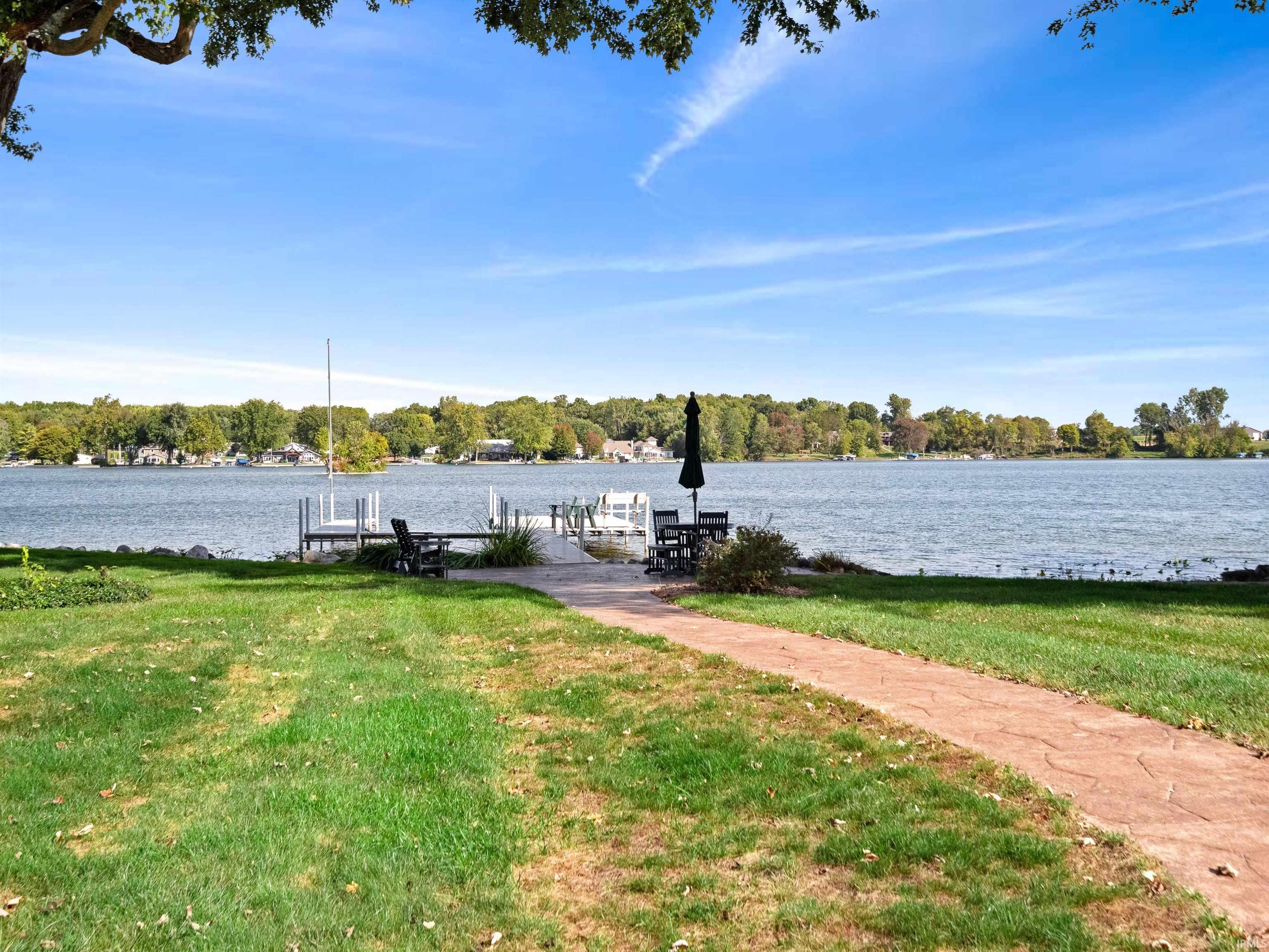 Dock area with a lawn, a water view, and boat lift