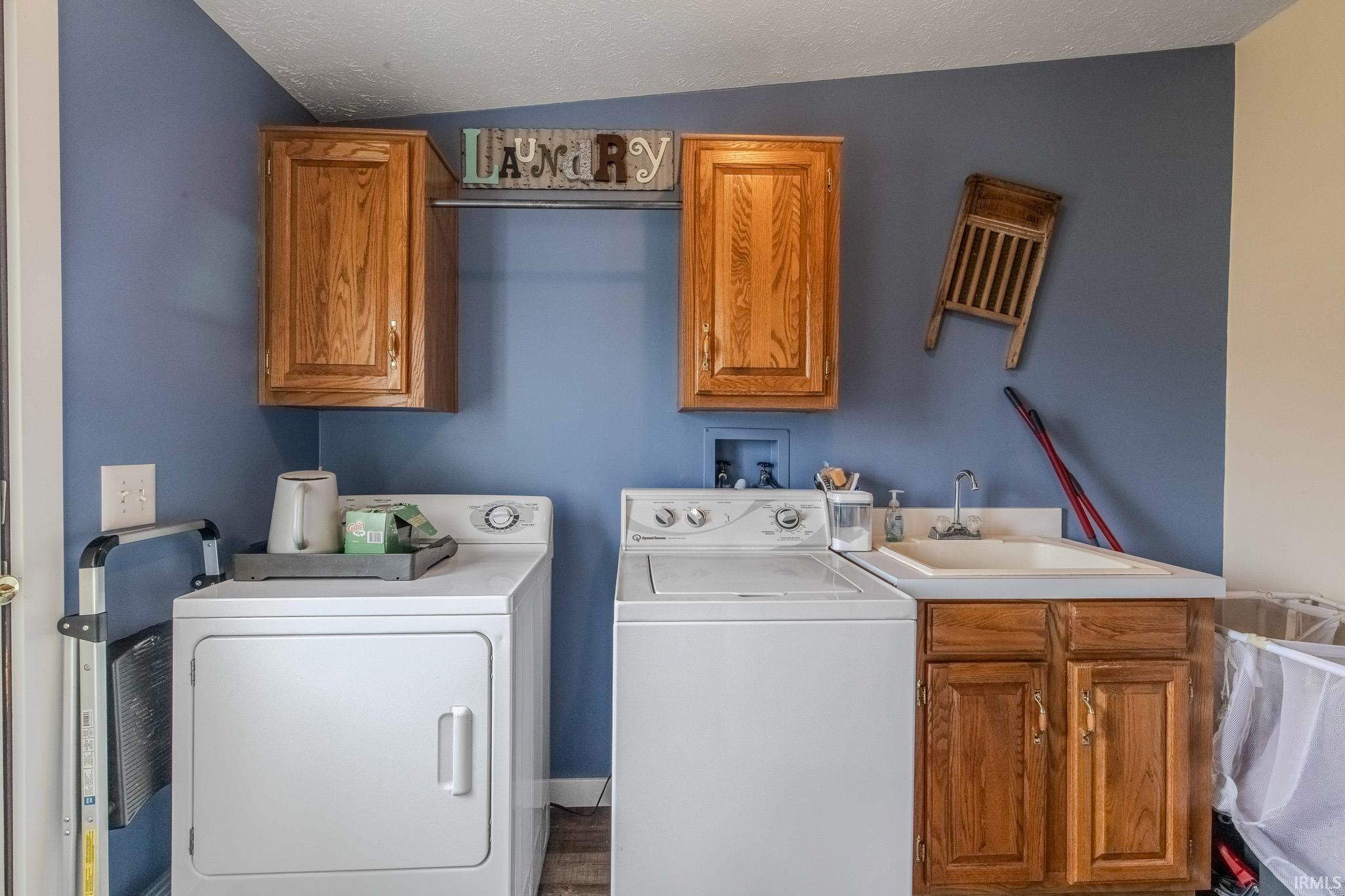 Laundry room with cabinet space and washer and clothes dryer