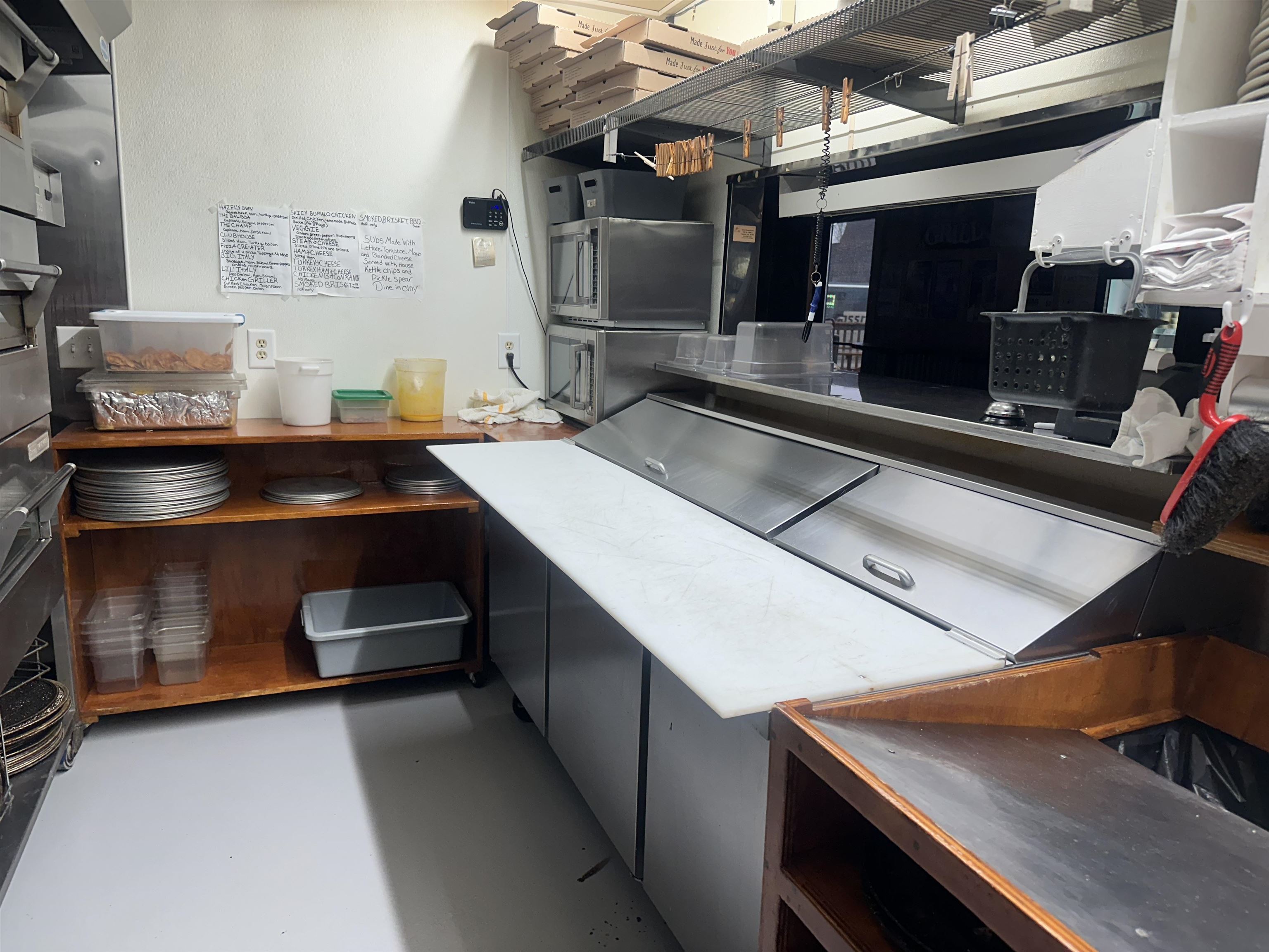Kitchen featuring stainless steel microwave and dark cabinetry