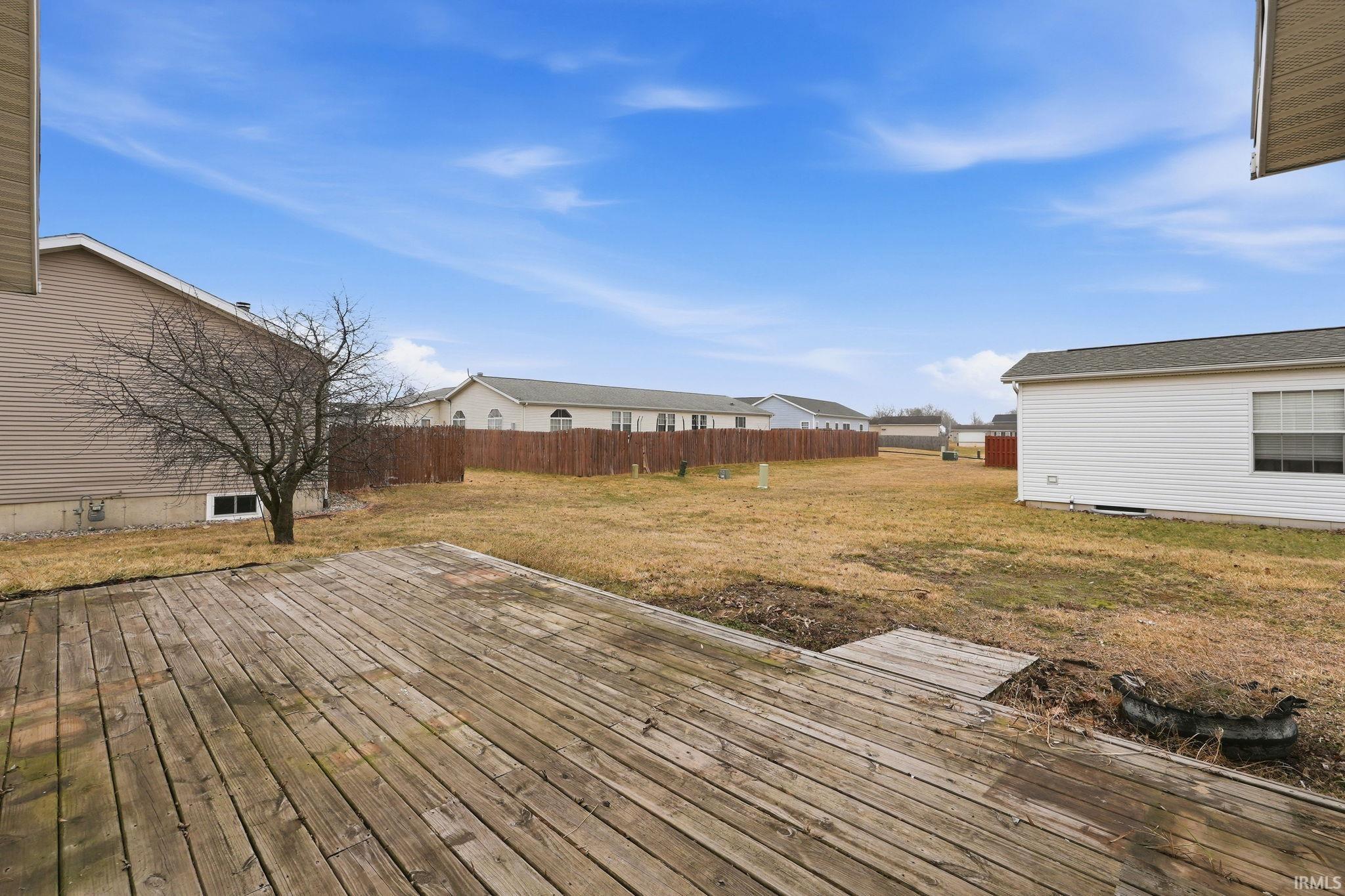 Wooden terrace featuring a residential view