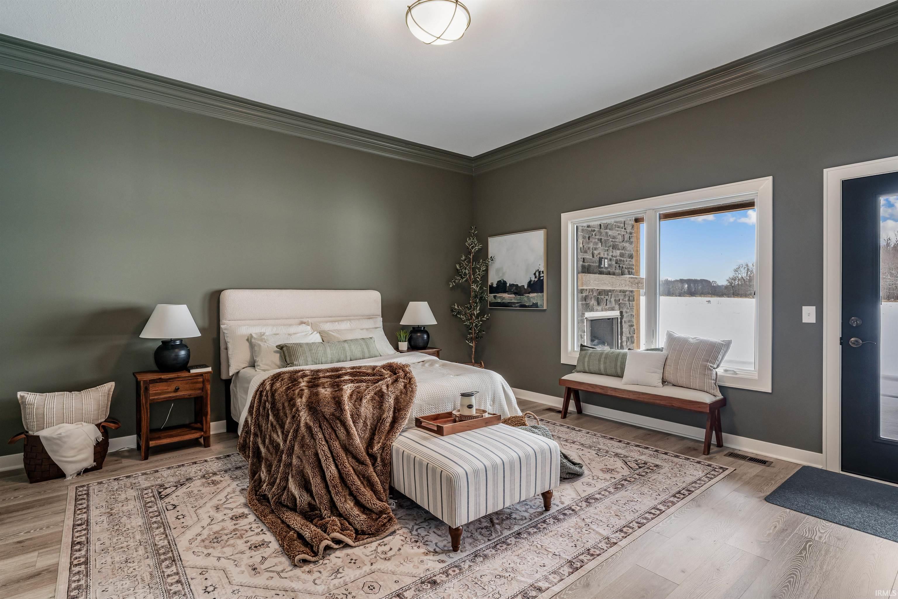 Bedroom featuring crown molding and light wood-style flooring