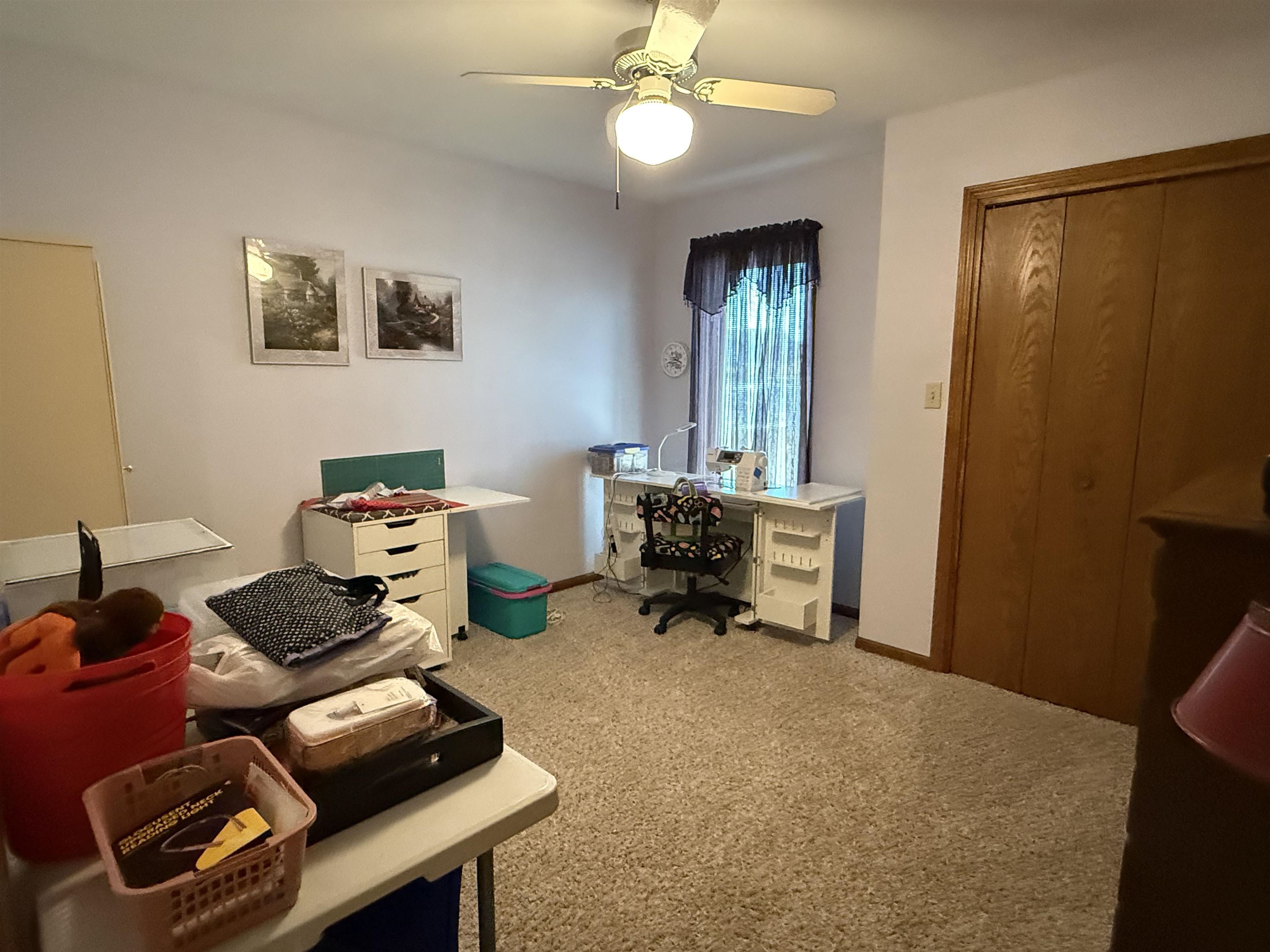 Office featuring light carpet and a ceiling fan