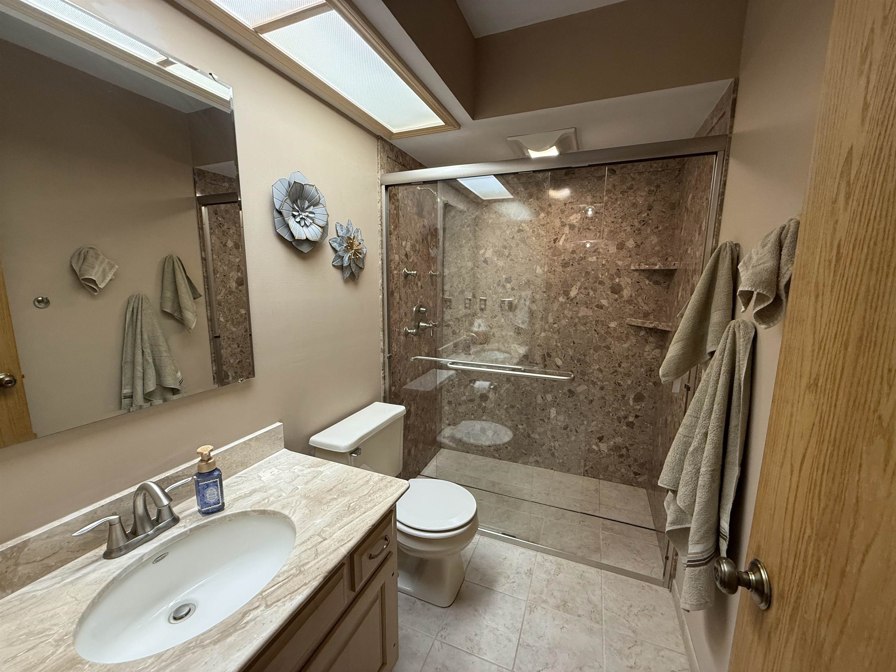 Bathroom featuring vanity and a shower stall