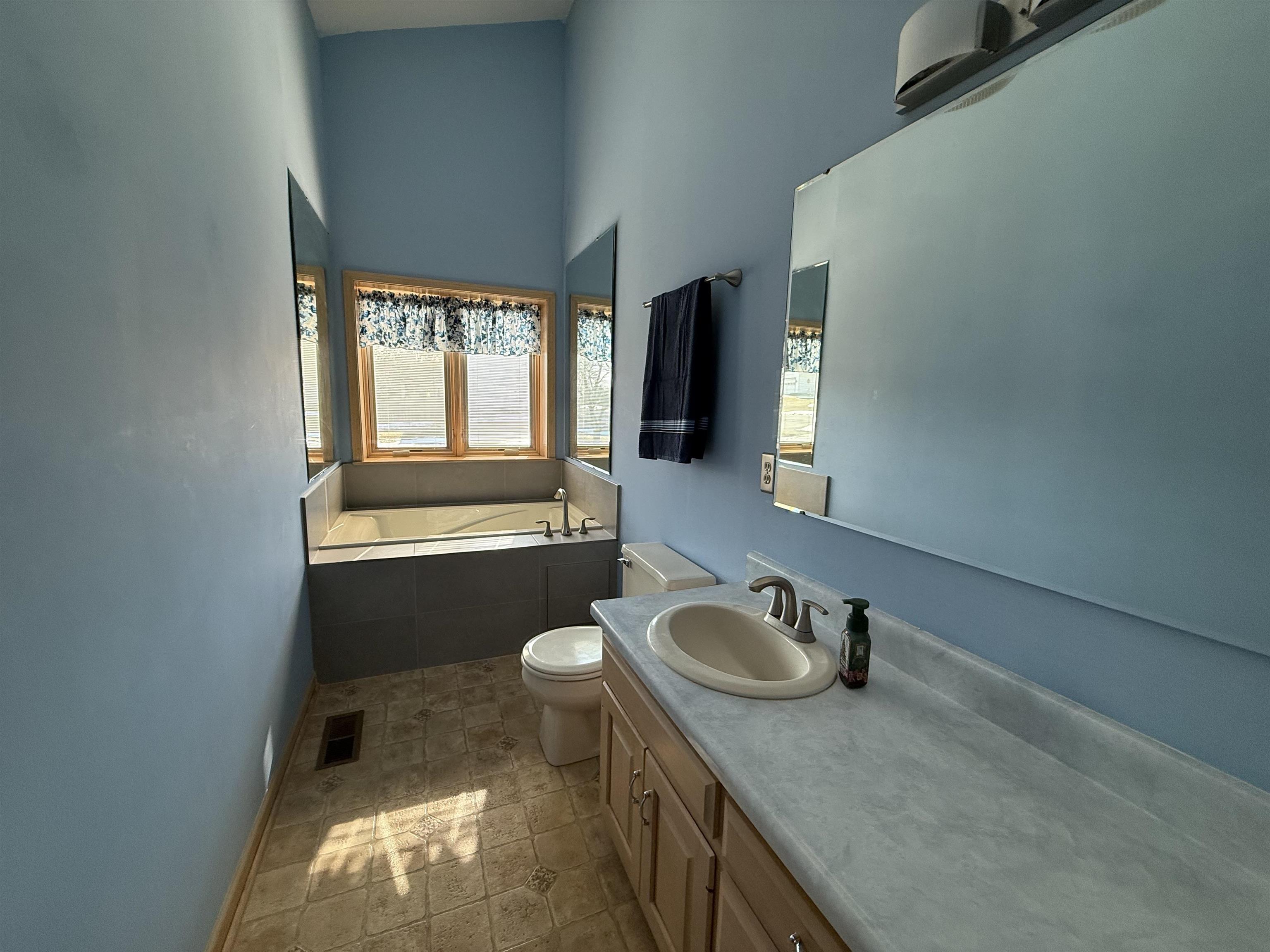 Full bathroom with a bath and vanity