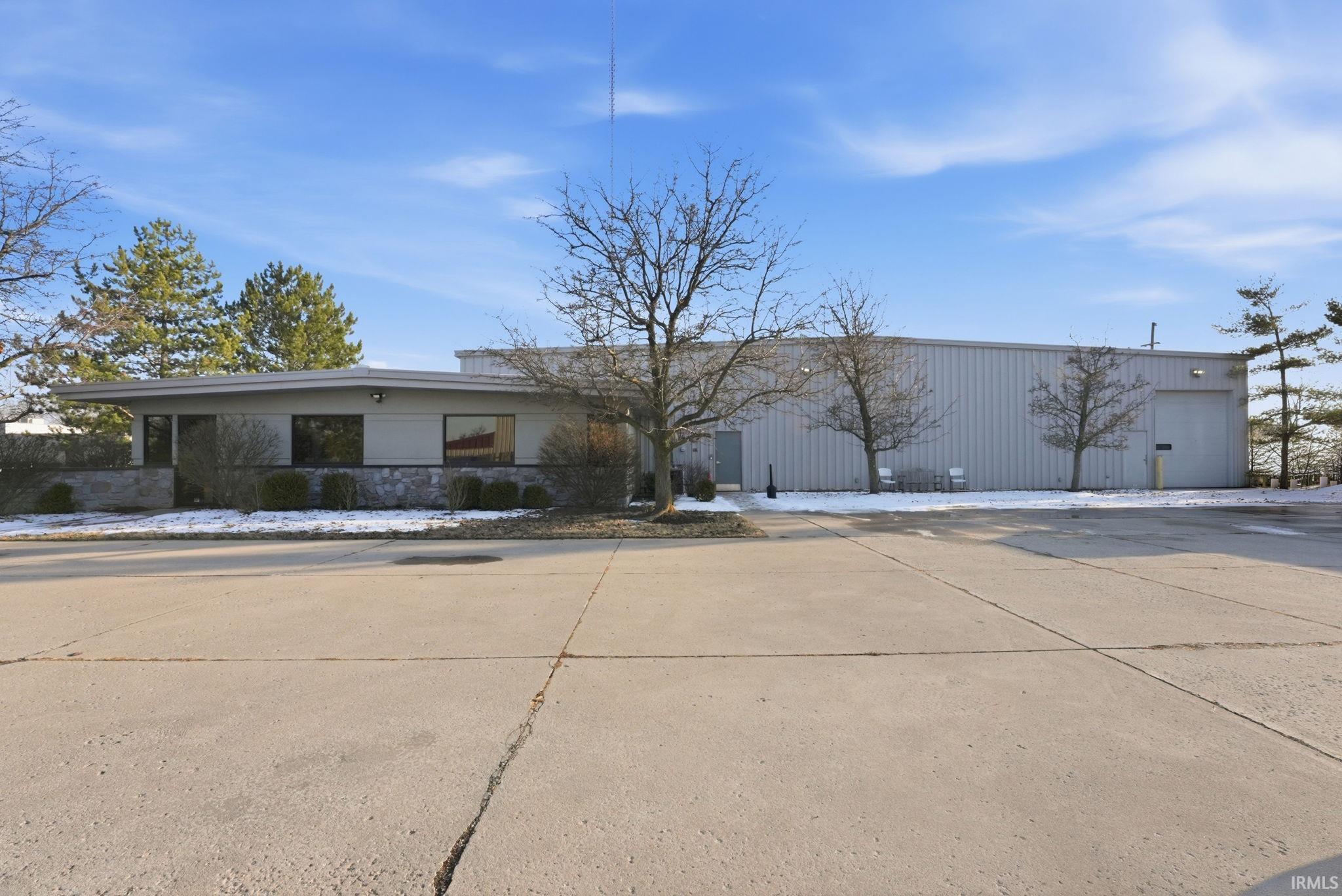 View of front of house featuring concrete driveway
