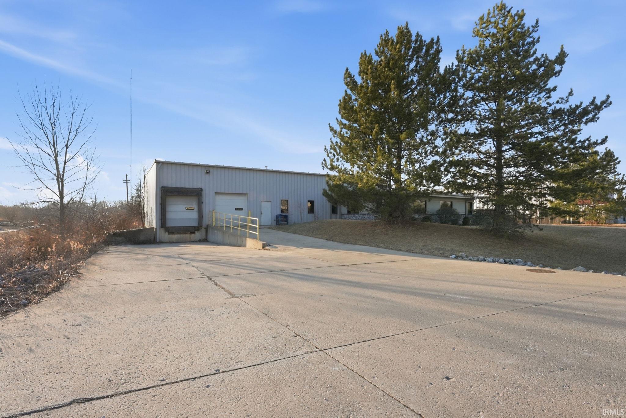 View of building exterior with concrete driveway