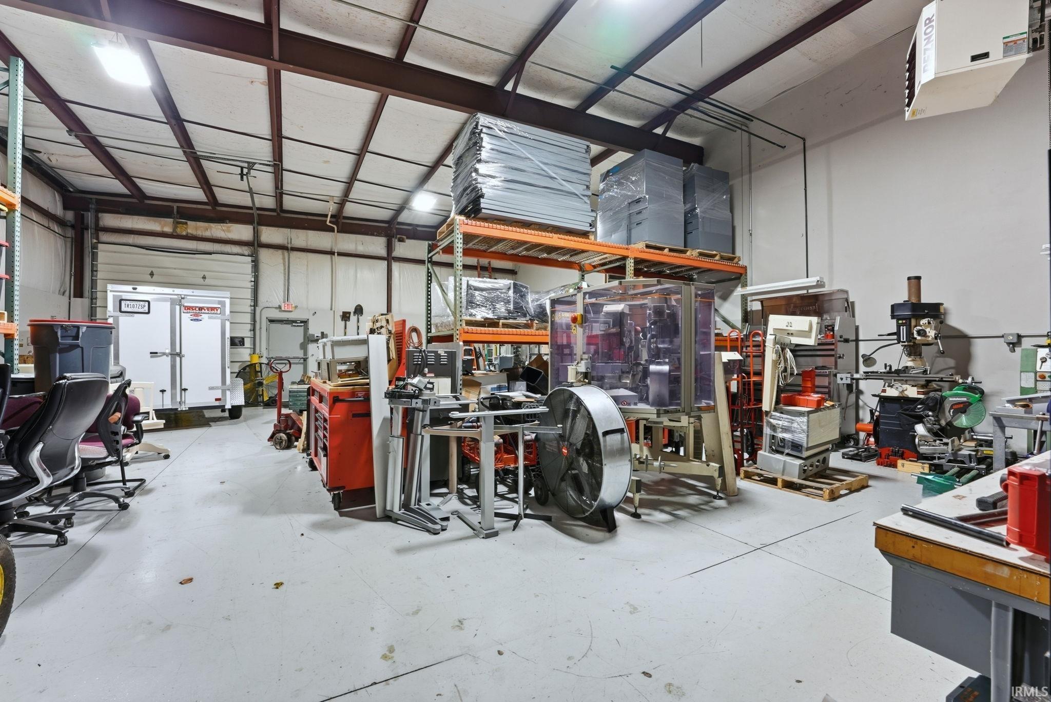 Garage with a heating unit and a workshop area