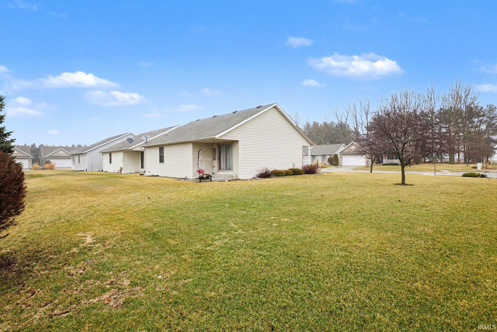 Back of house featuring a yard