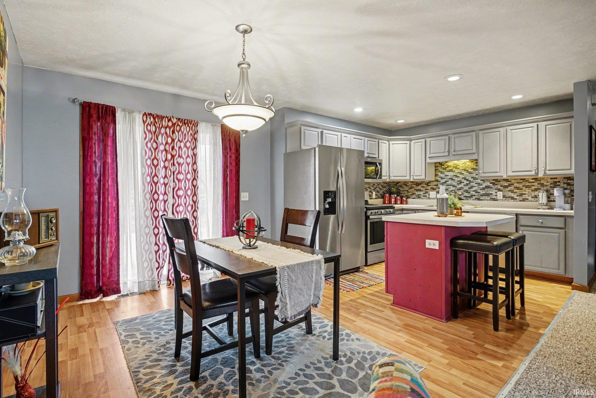 Dining area featuring light wood finished floors and recessed lighting