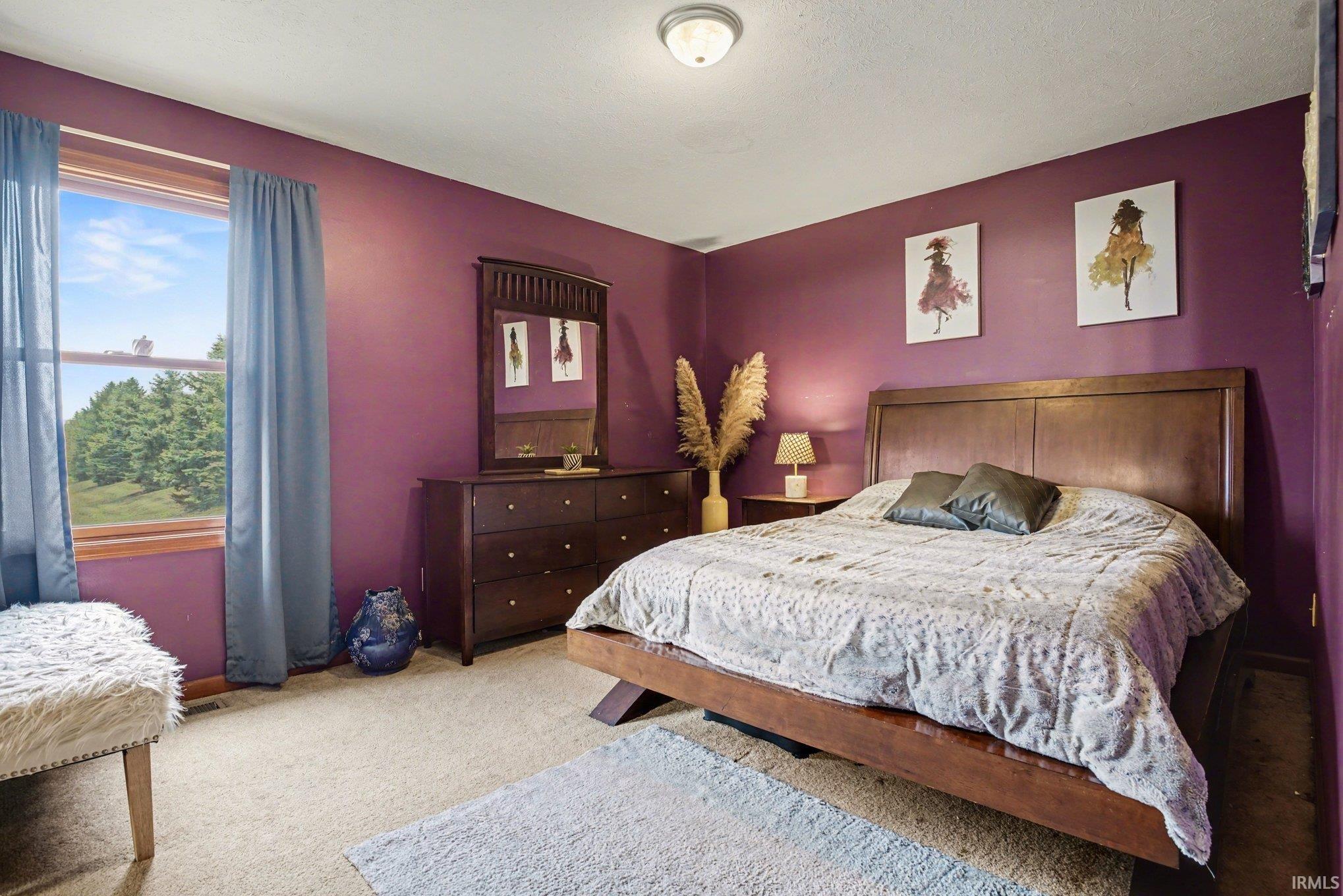Bedroom with light colored carpet