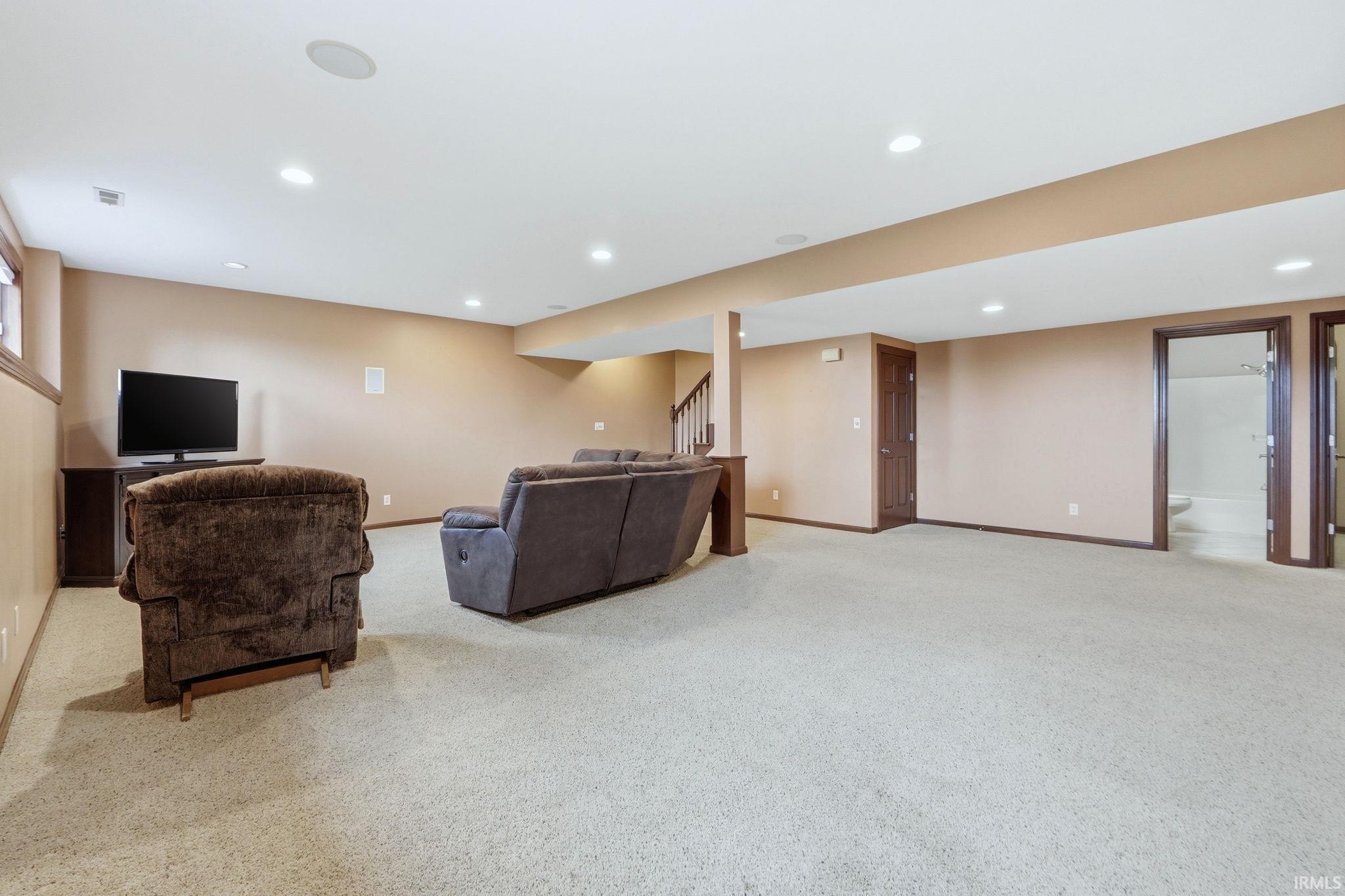 Living room featuring light colored carpet and recessed lighting