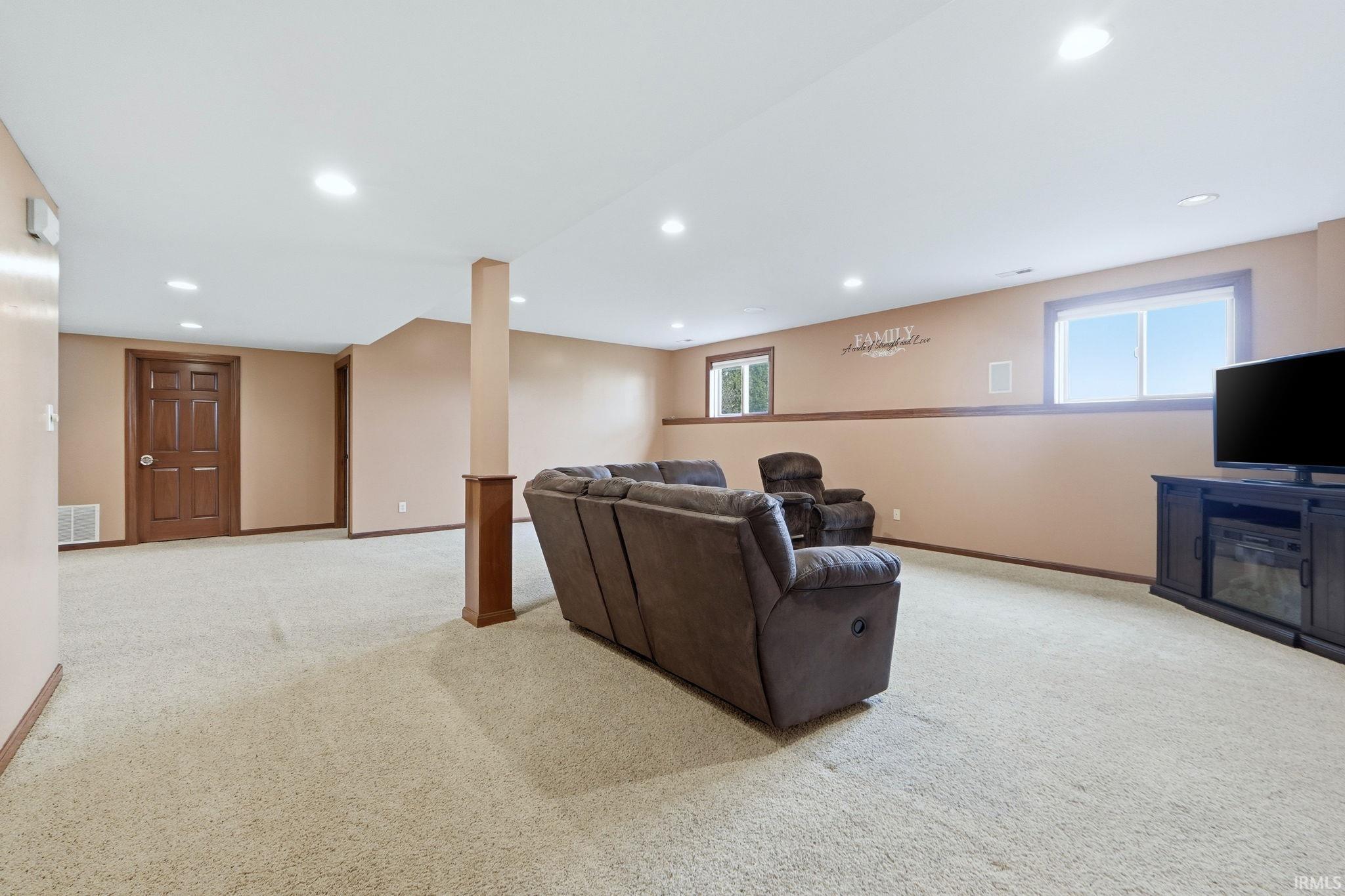 Living area featuring light carpet and recessed lighting