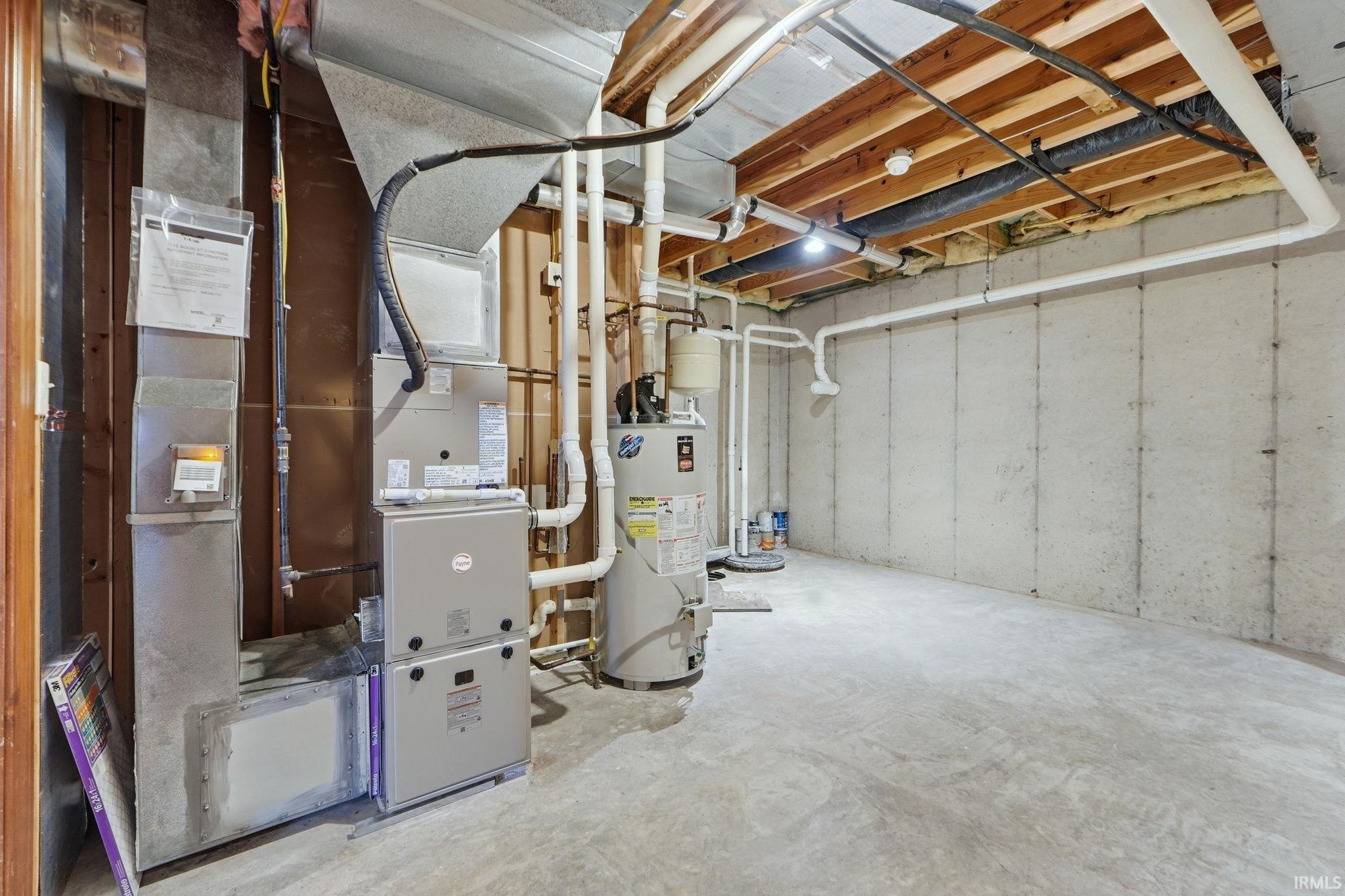 Unfinished below grade area with water heater and heating unit