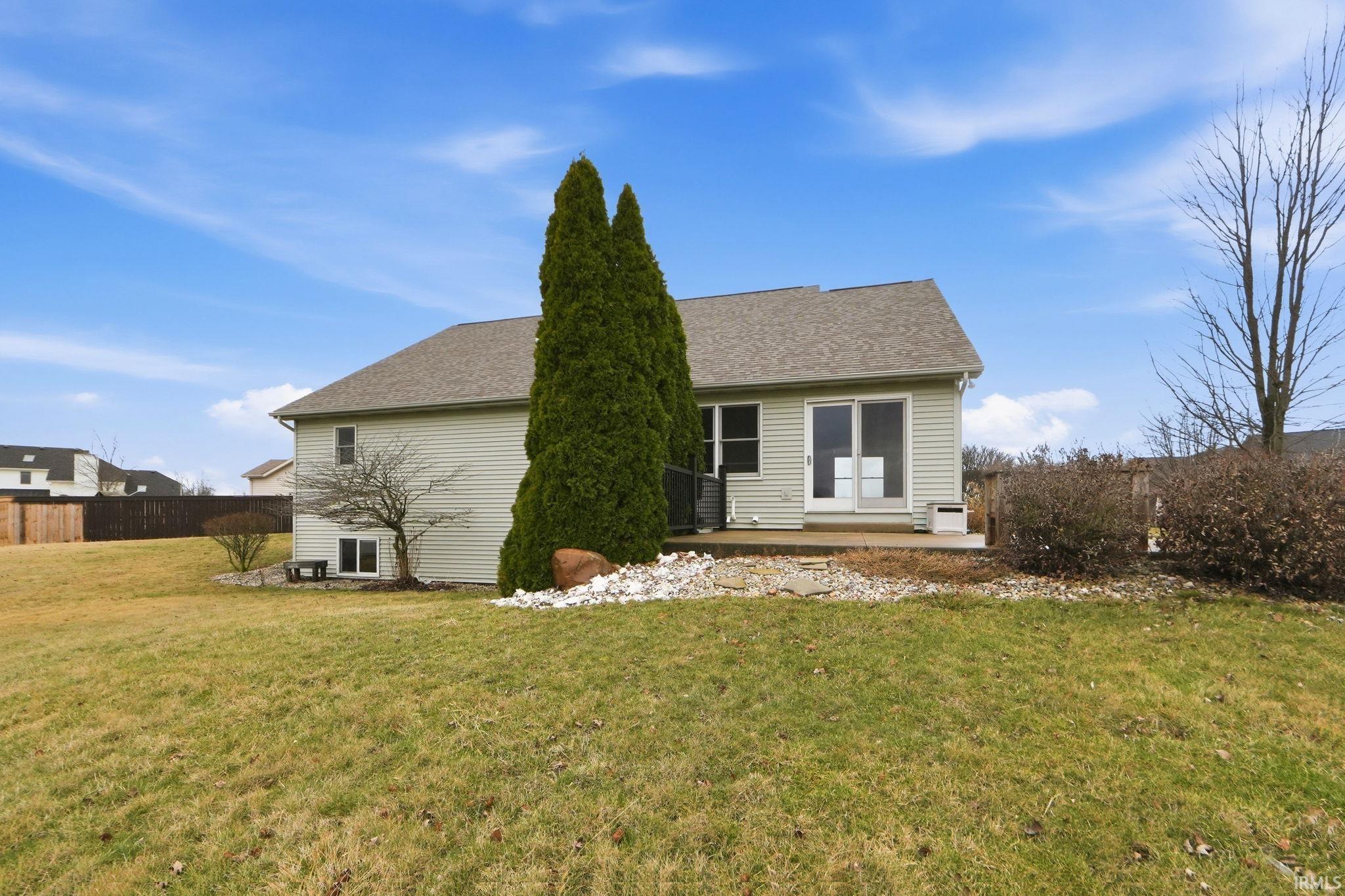 Rear view of property with a patio and a shingled roof